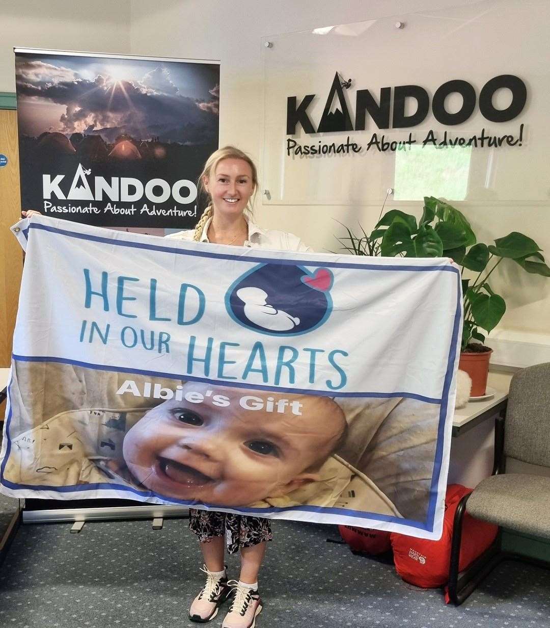 Lauren McFarland of Kandoo Adventures with the flag that is now making its way to Everest.