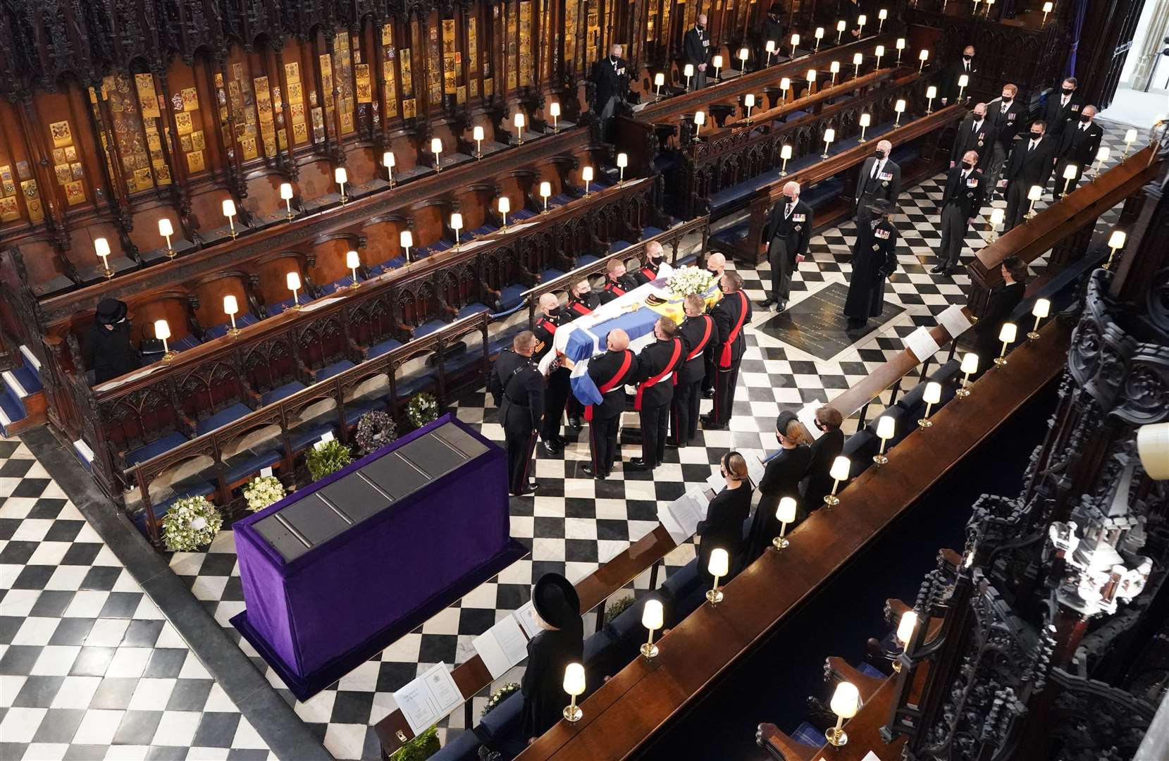 The Queen watches as pallbearers carry the coffin of the Duke of Edinburgh into St George’s Chapel (Dominic Lipinski/PA)