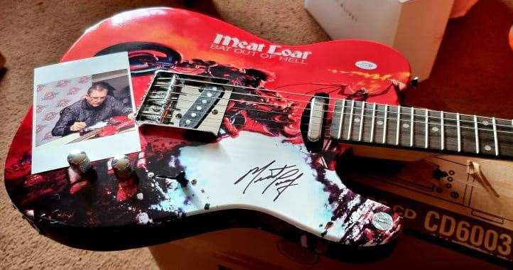 Ms Allender has a customised guitar Meat Loaf signed for her (Sandra Allender/PA)