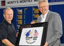 Alister Henry (left) receives his prize from Colin Montgomerie
