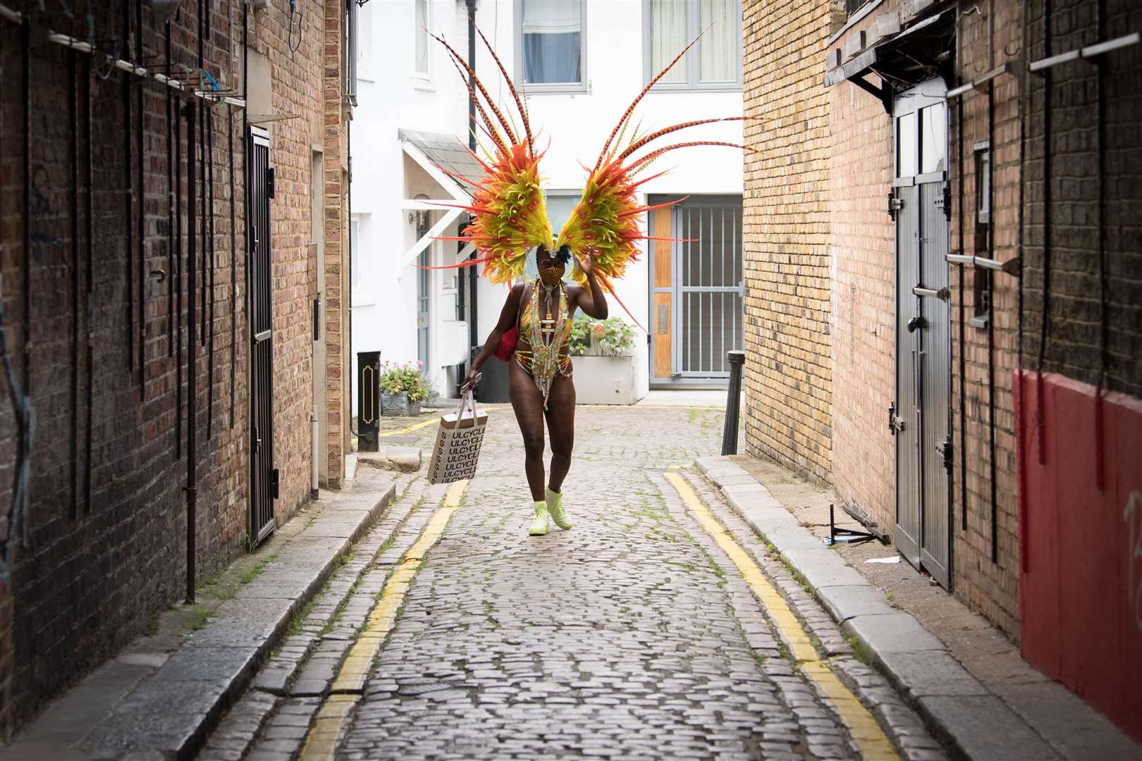 A woman in costume heading to take part in the online Notting Hill Carnival, north London, after the 2020 carnival was cancelled (Stefan Rousseau/PA)