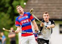 The caman of Lovat's Lewis Tawse gets close to Kingussie's Louis Munro in the Kings' 2-1 Scottish Hydro Camanachd Cup win at Balgate, Kiltarlity, on Saturday.