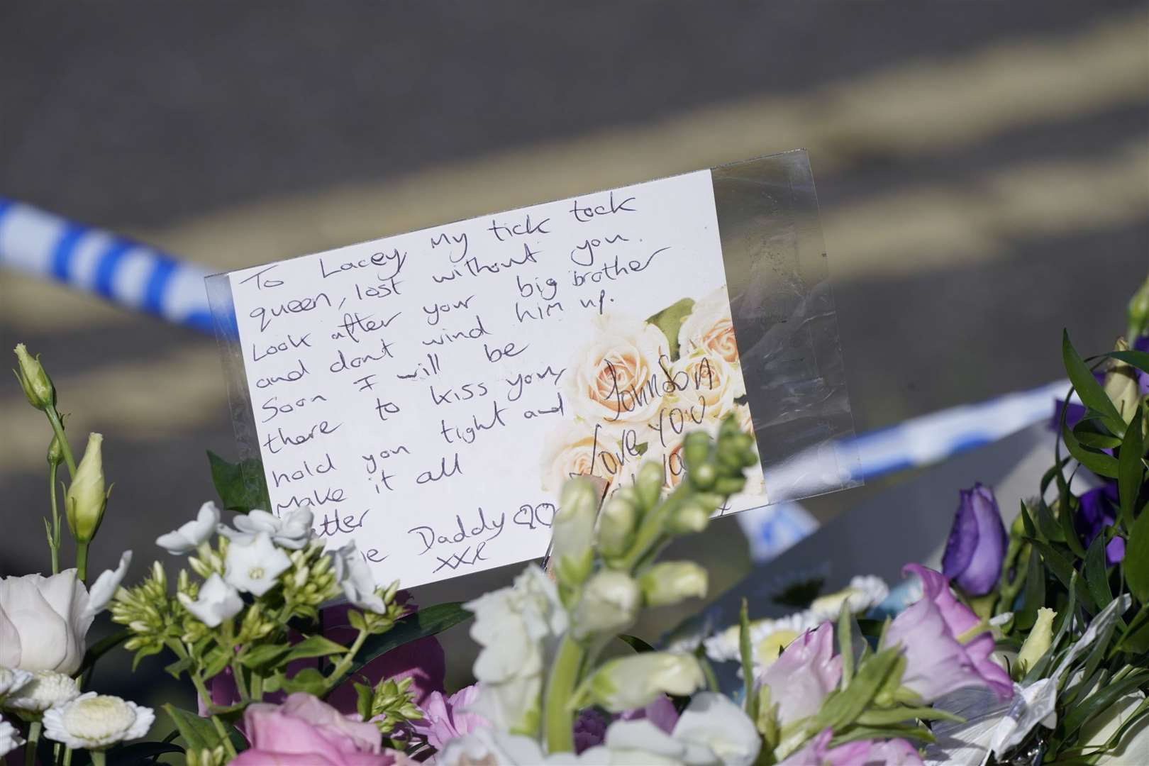 Messages left by the father to one of the victims on bouquets of flowers at the scene in Chandos Crescent (Danny Lawson/PA)
