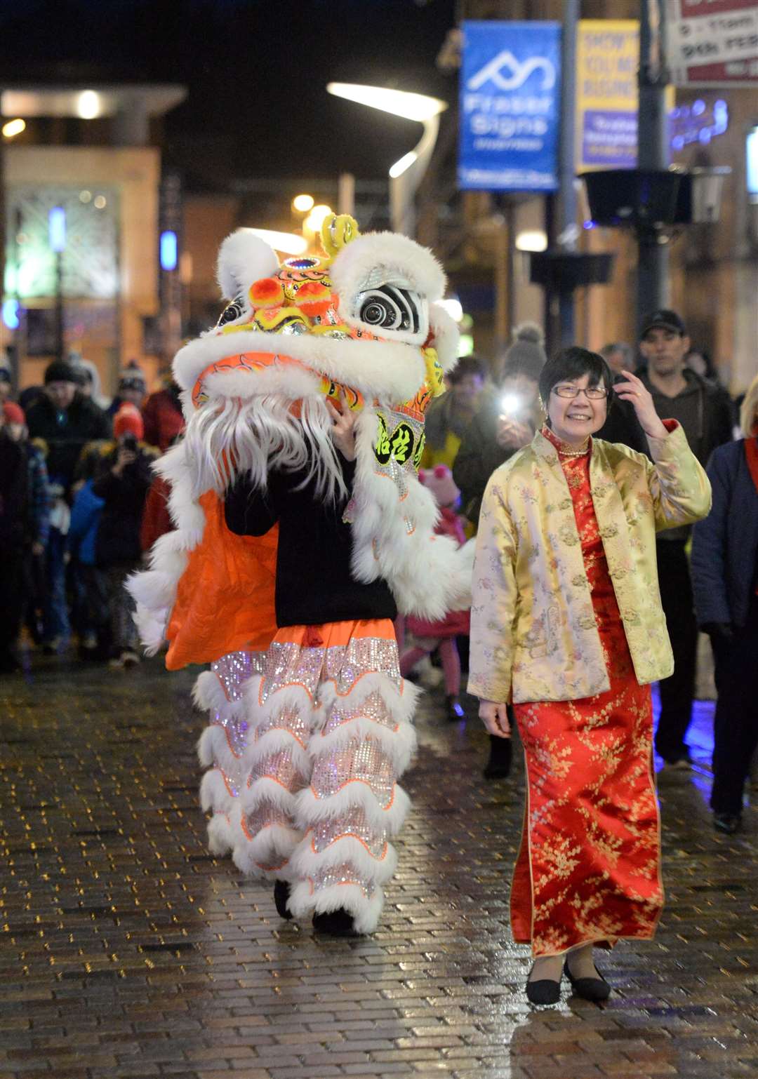 Monica Lee-MacPherson leads the Lion Dance along the High Street. Picture: Gary Anthony