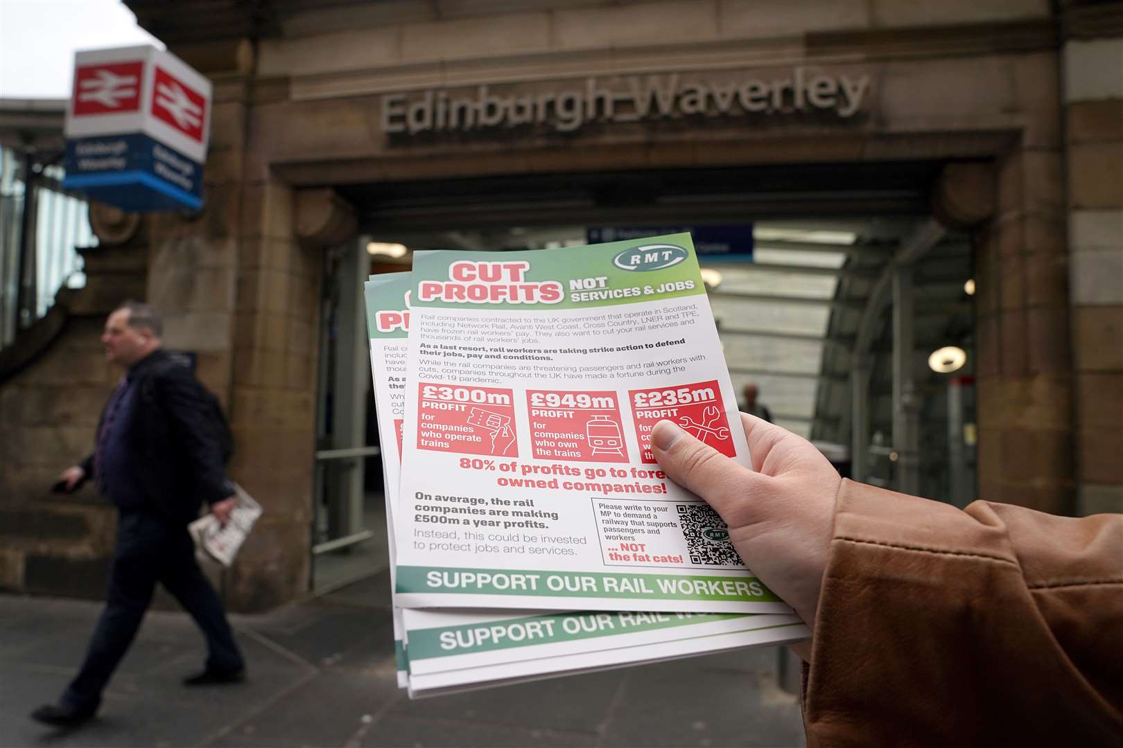 Members of the RMT picket at the entrance to Waverley station in Edinburgh (Andrew Milligan/PA)