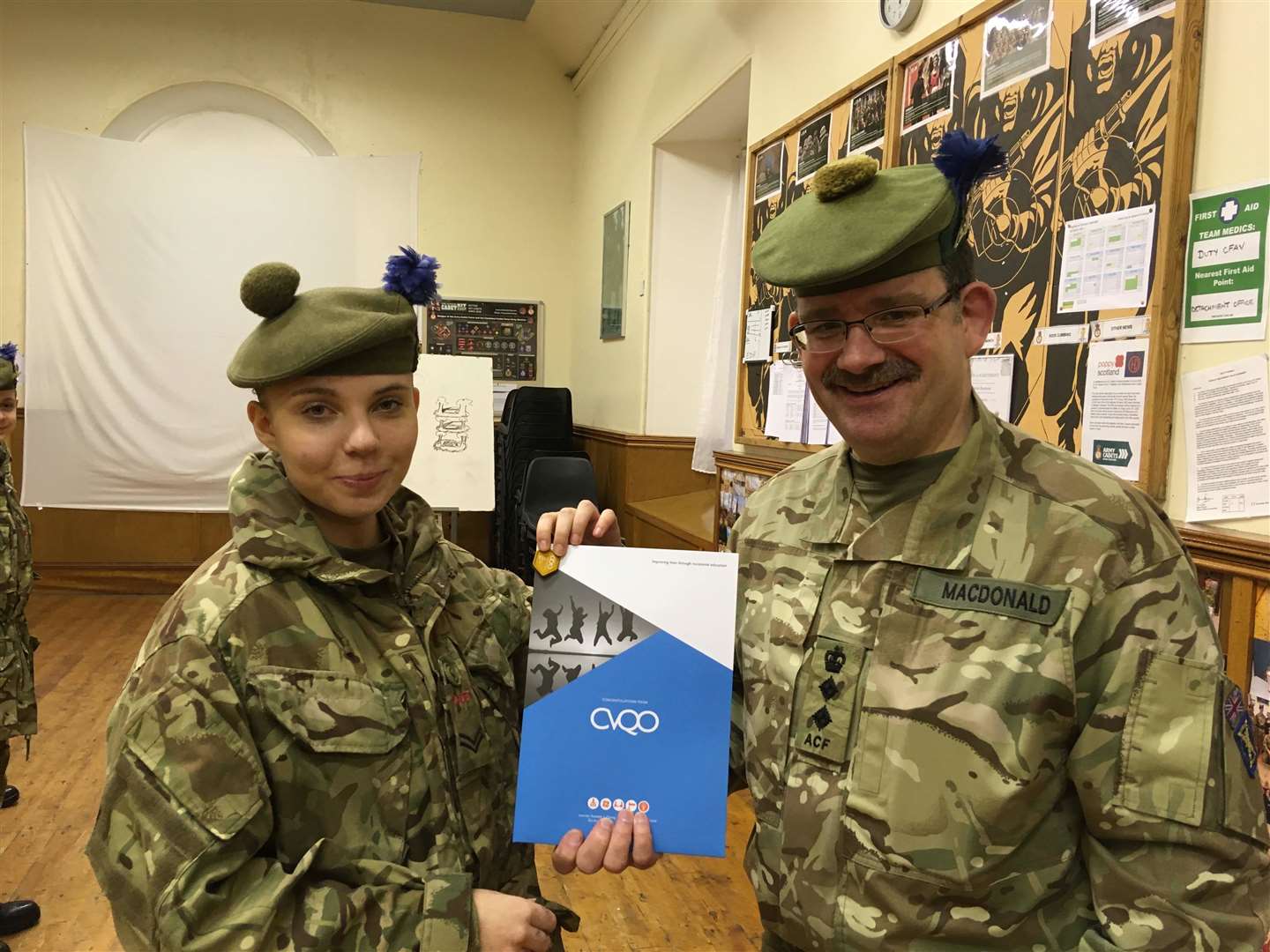 Cpl Daniela Rusmane is presented with her certificate by the 1st Battalion The Highlanders Commandant, Colonel Mike MacDonald.