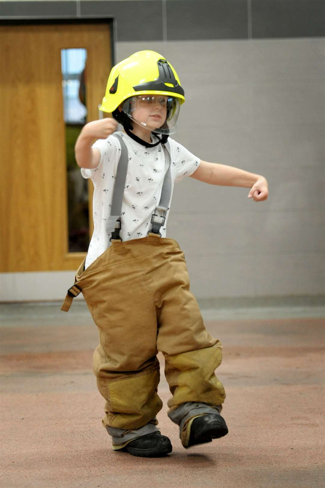 Archie Holmes tries out some of the firefighter's gear.