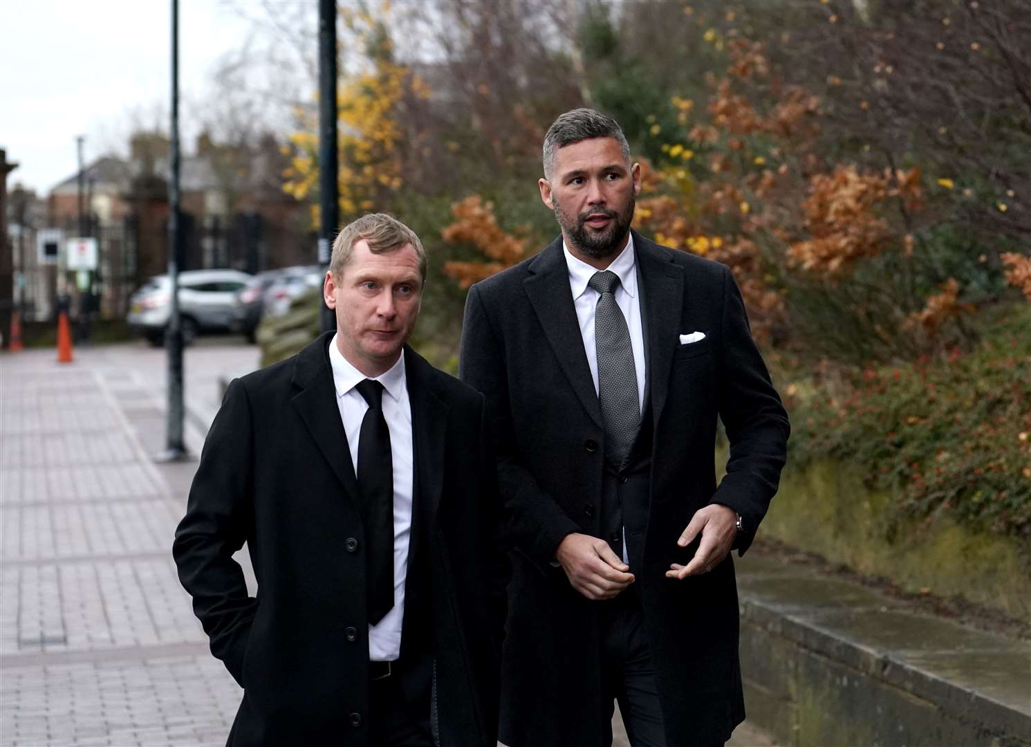 Former Everton player Tony Hibbert (left) and former boxer Tony Bellew (right) arrive at the service (Martin Rickett/PA)