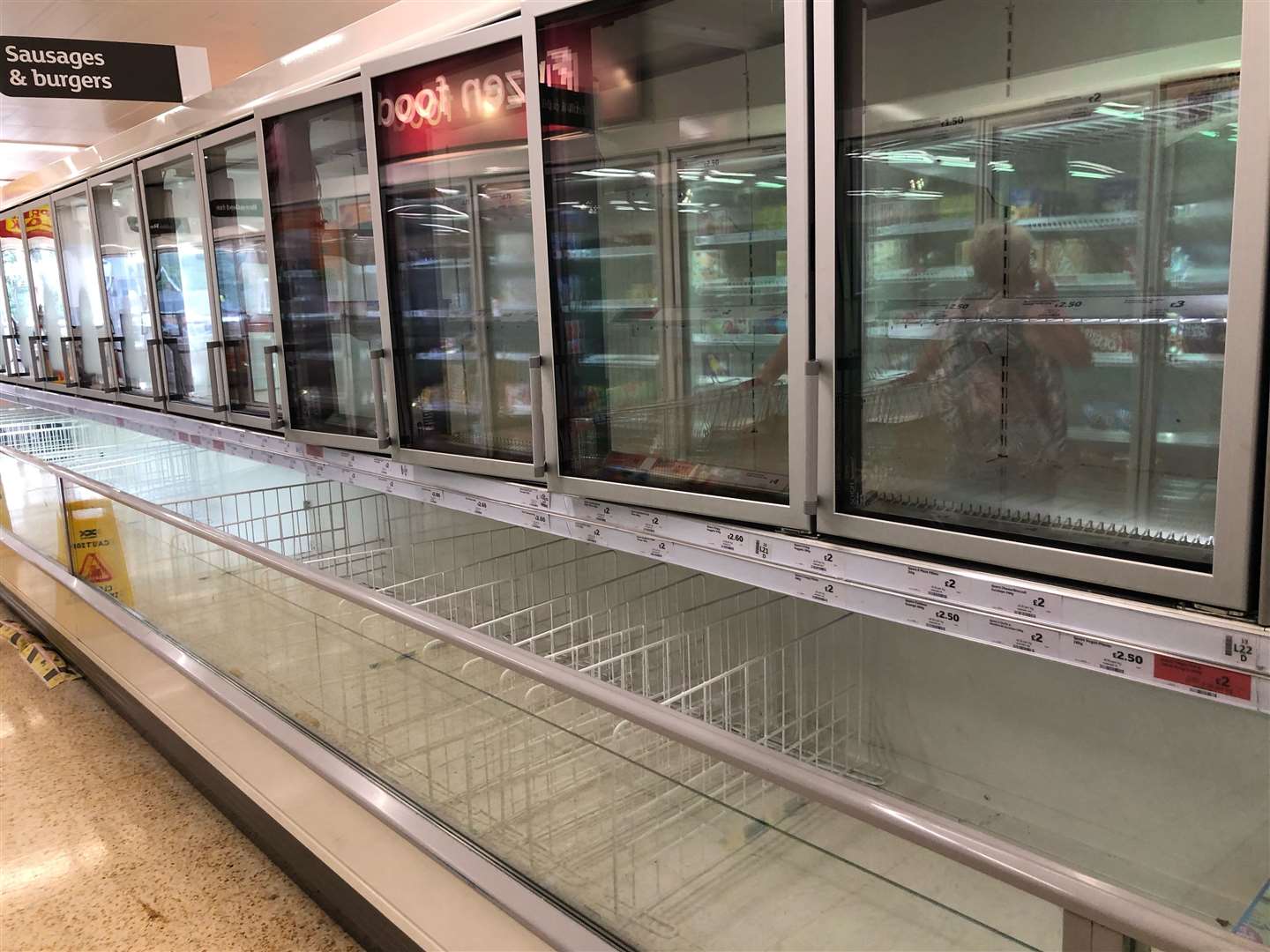The empty sausage and burger section of the freezer aisle at a Sainsbury supermarket (PA)