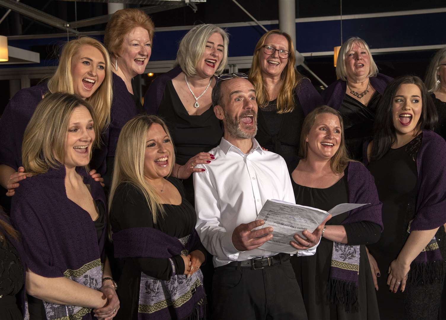 Barry Laird General Manager of Vue Inverness singing along with The Inverness Military Wives Choir.