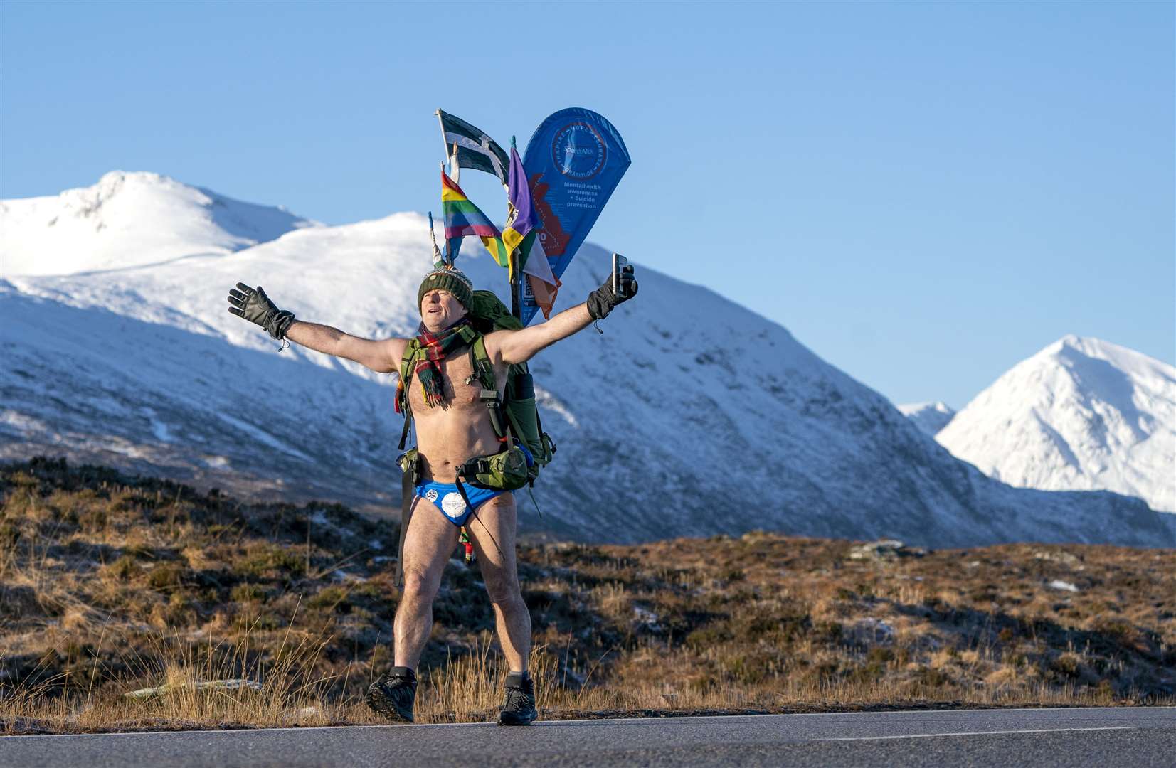 Mick Cullen, otherwise known as Speedo Mick, walks through Glencoe in sub-zero temperatures wearing only his swimming trunks (Jane Barlow/PA)