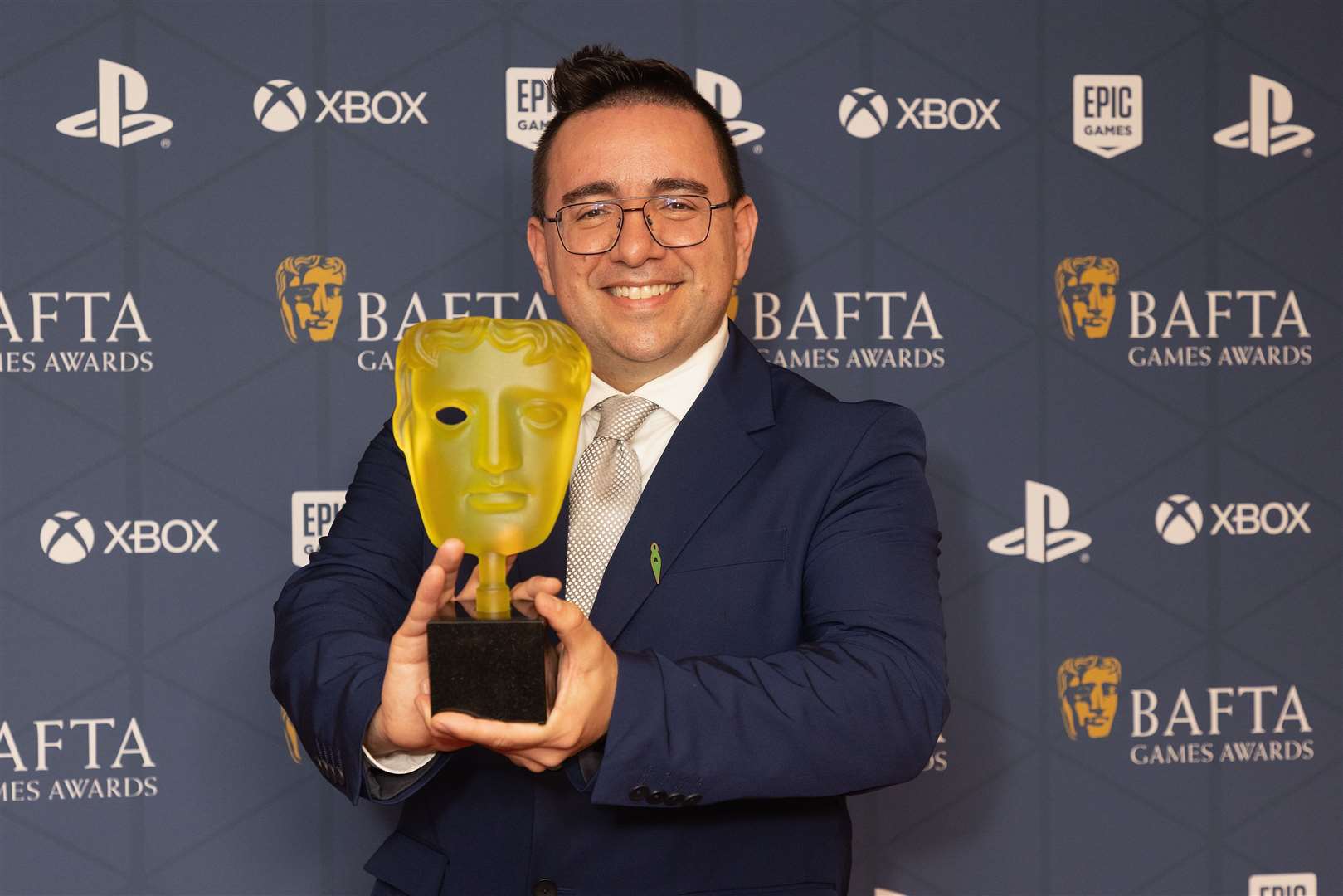Bruno Velazquez, from Santa Monica Studio/Sony Interactive Entertainment, with the EE game of the year award for God Of War Ragnarok (Suzan Moore/PA)