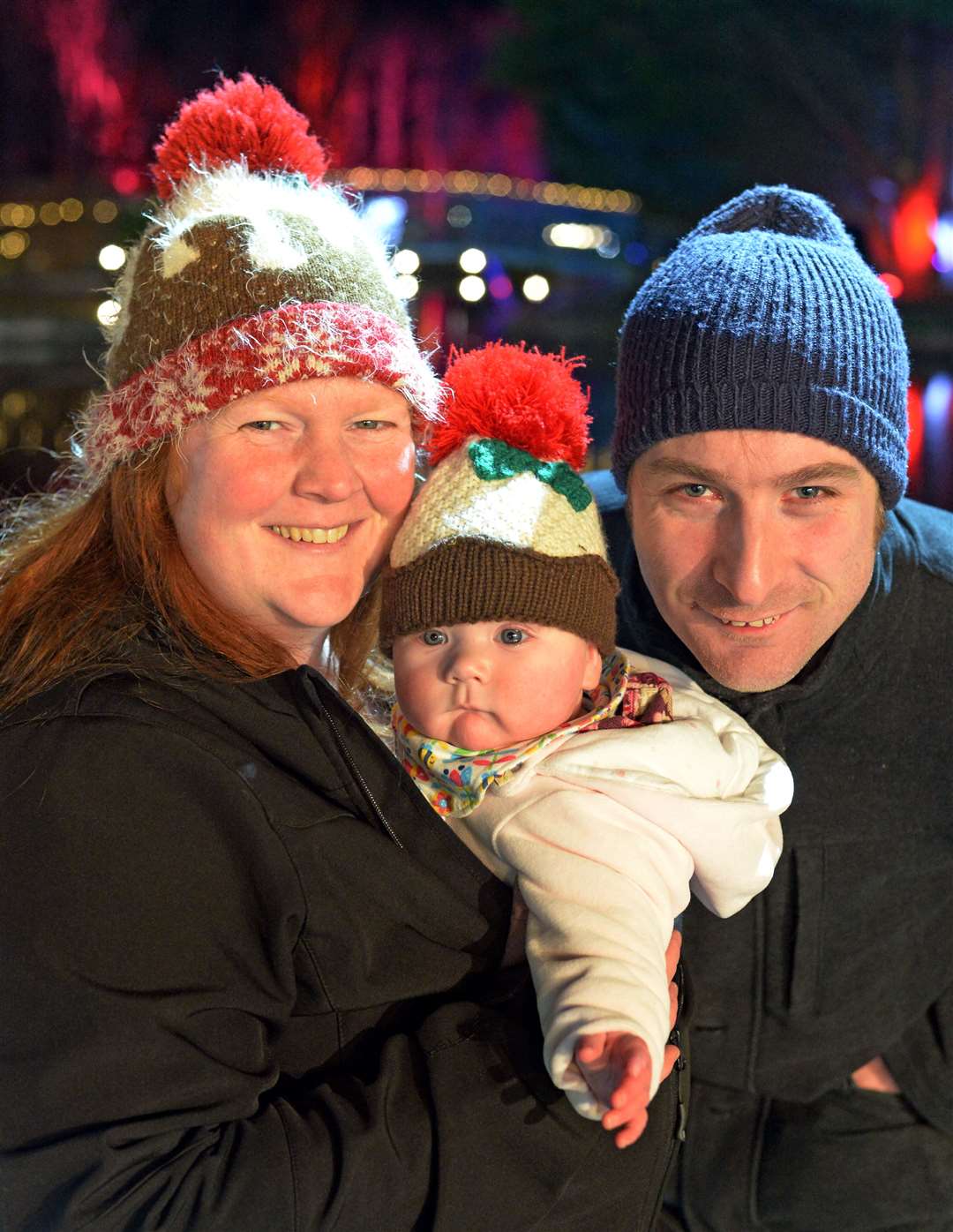 Faeryn Graham stayed warm in his Christmas pudding hat. He's pictured with mum and dad Shona Leggatt and Fergus Graham. Picture: Gair Fraser.