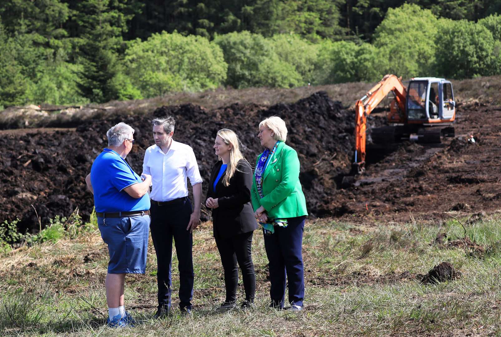 Minister of Justice Simon Harris, Senator Emer Currie and Minister for Social Protection Heather Humphreys with Oliver McVeigh, left, the brother of Columba McVeigh, at Bragan Bog in Co Monaghan (Peter Morrison/PA)