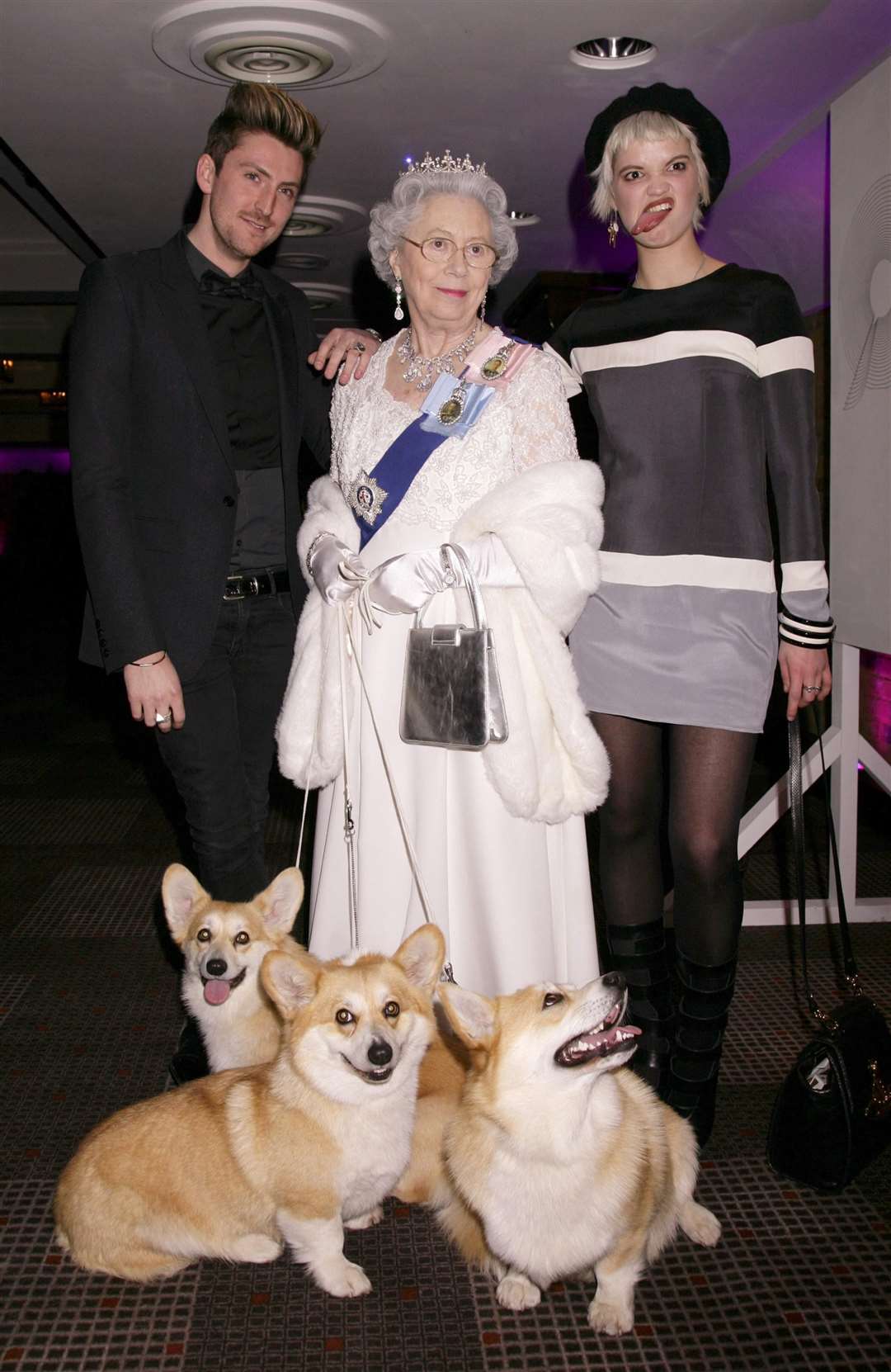 Henry Holland and Pixie Geldof pose with Ms Reynolds. Ms Reynolds has been a lookalike since 1988 (Yui Mok/PA)