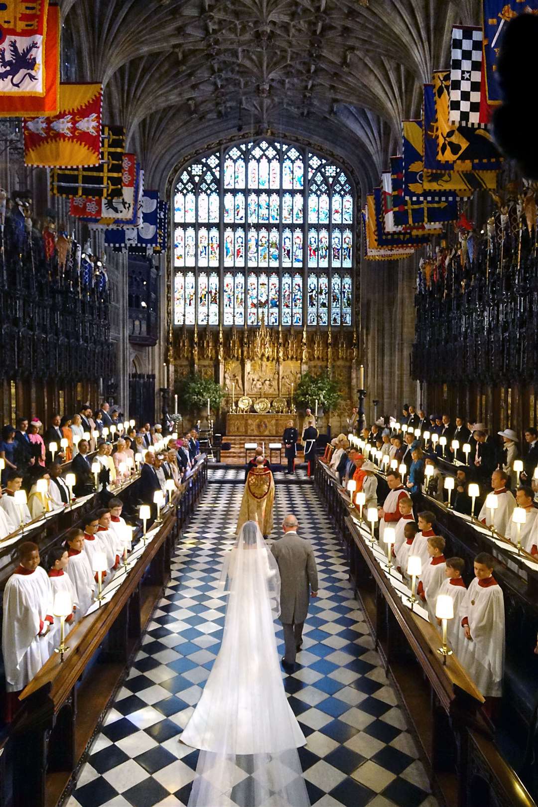 The Prince of Wales walking Meghan Markle up the aisle of St George’s Chapel in 2018 (Dominic Lipinski/PA)