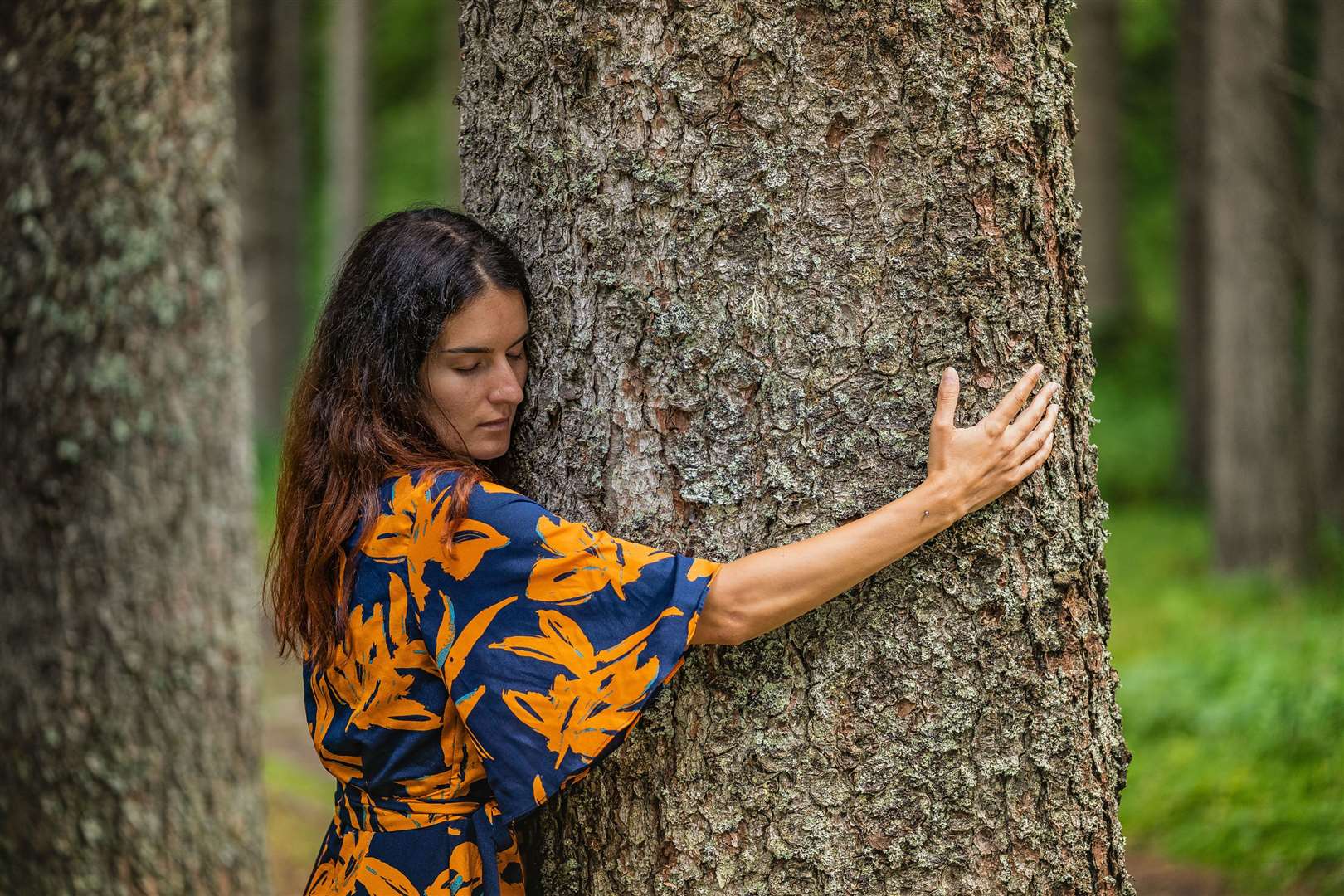 Tree hugging therapy in the Val Di Sole. Picture: PA Photo/Tommaso Prugnola.