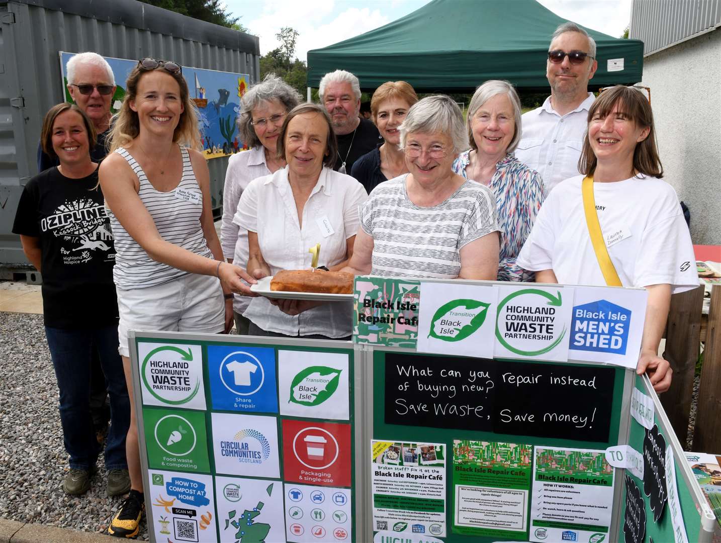 Repair Cafe volunteers with 1st birthday cake (l-r): Katy Jenkins, Richard Evans, Rose Grant, Cate Scrim, Gillian Newman, Robin Witheridge, Sheena Ross, Janet Witheridge, Alison Garroway, James Todd and Laura Donnelly.