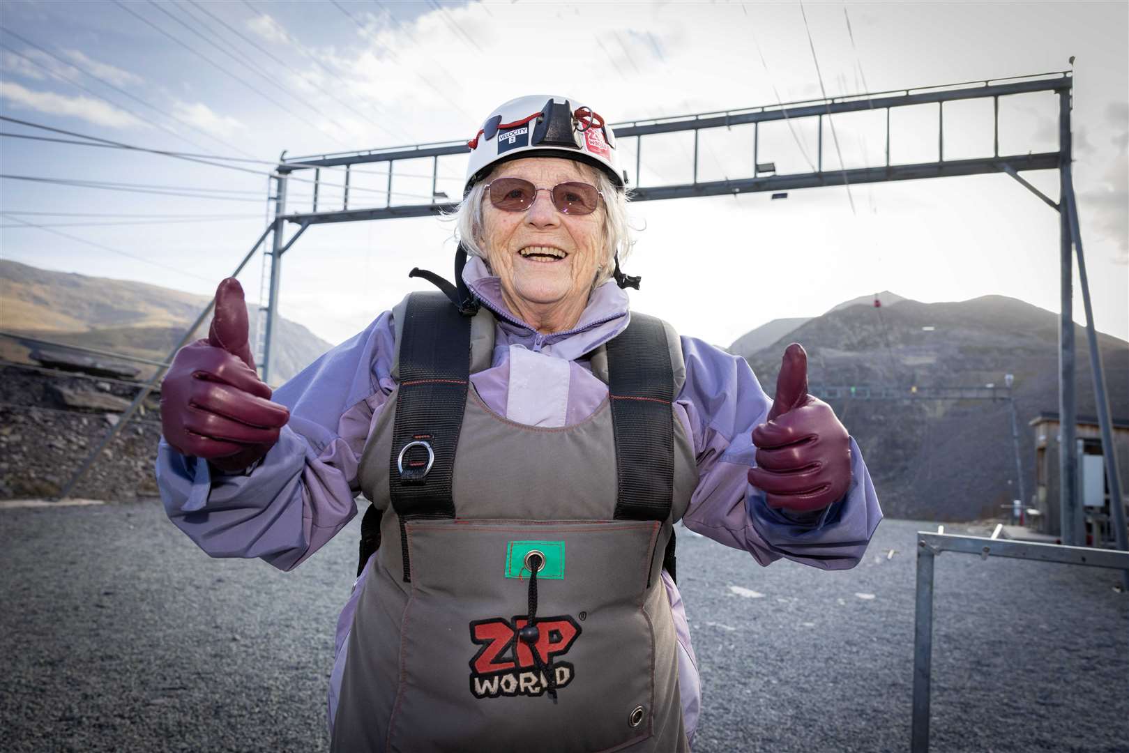 Ms Webster gives a thumbs up after her daring zipline over Penrhyn Slate Quarry in North Wales (Care UK/ Darren Robinson)
