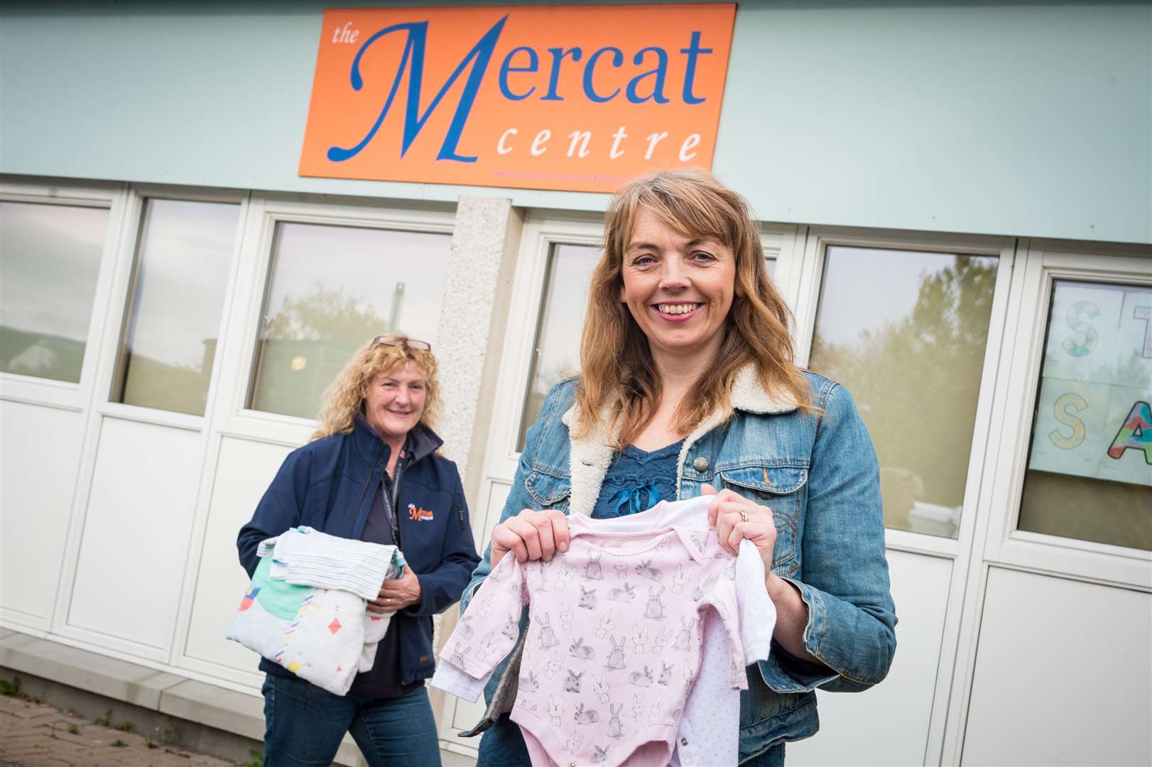 Dawn Aird (right), of Kildary near Tain, is organising a collection of baby clothes for a children's hospital in Yemen. Pictured with Mercat Centre manager Mairi Crow. Picture: Callum Mackay