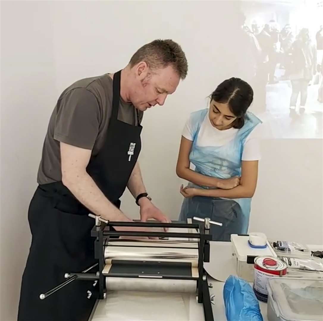 Studio manager John McNaught shows how to print and press.