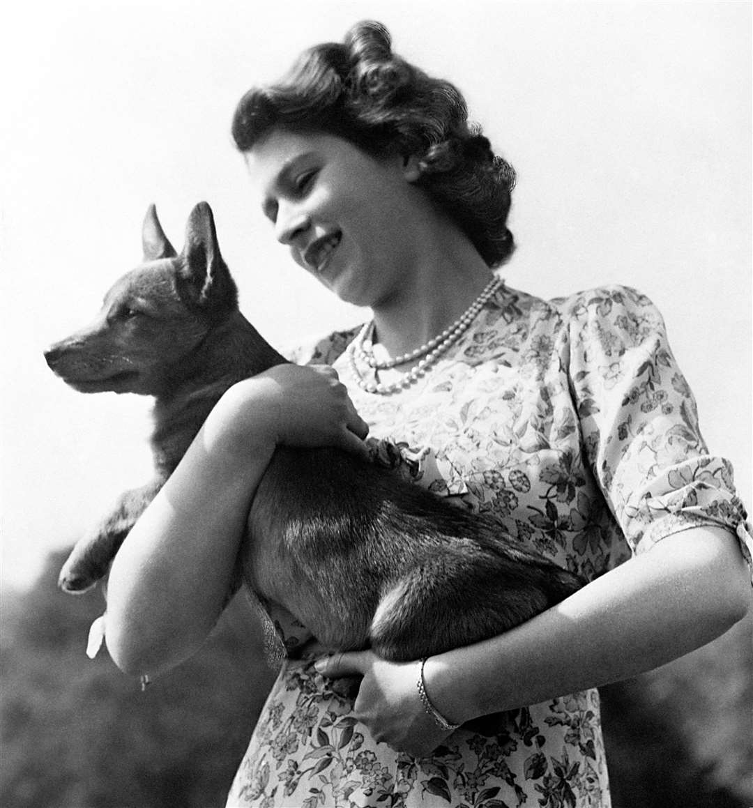 Princess Elizabeth holding a corgi in 1950 (PA)
