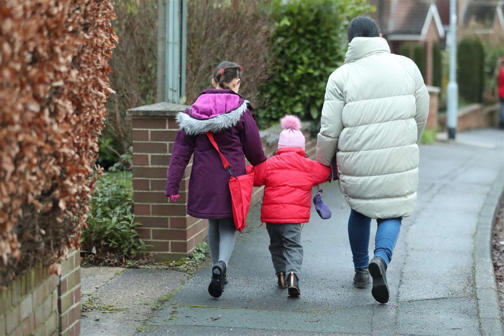 Schoolchildren make their way to primary school in Leeds (PA)
