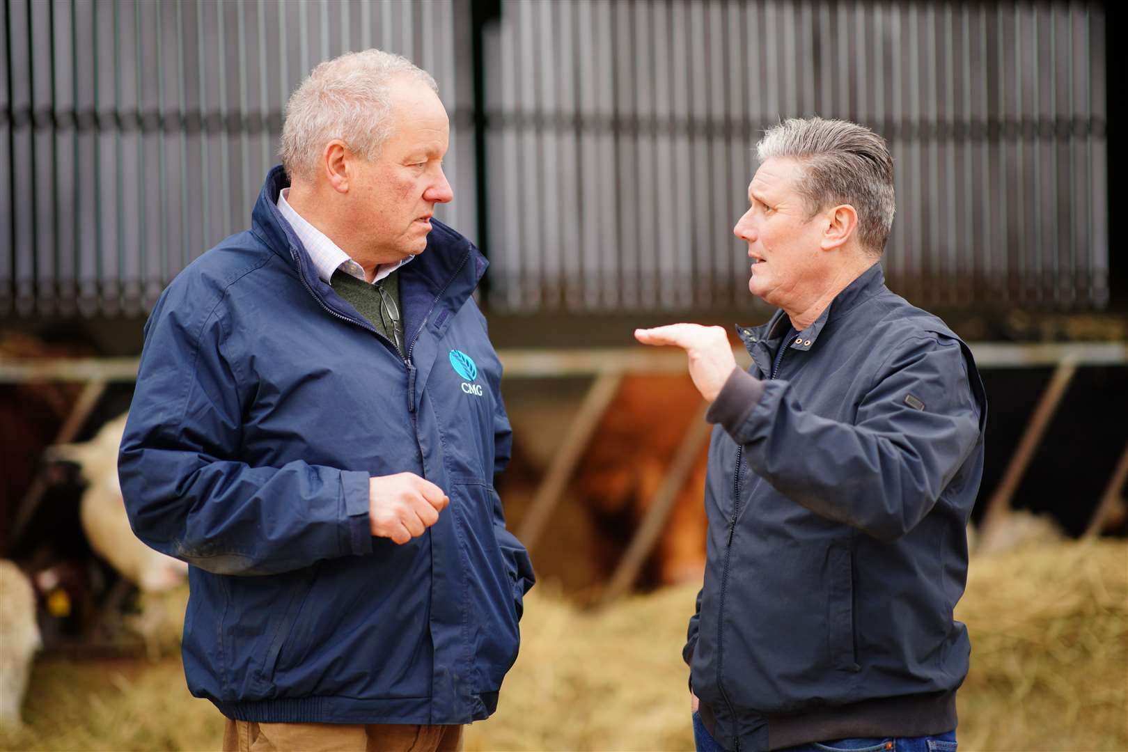 Sir Keir Starmer (right) speaks to Rupert Inkpen, the owner of Home Farm, Solihull, West Midlands (Ben Birchall/PA)