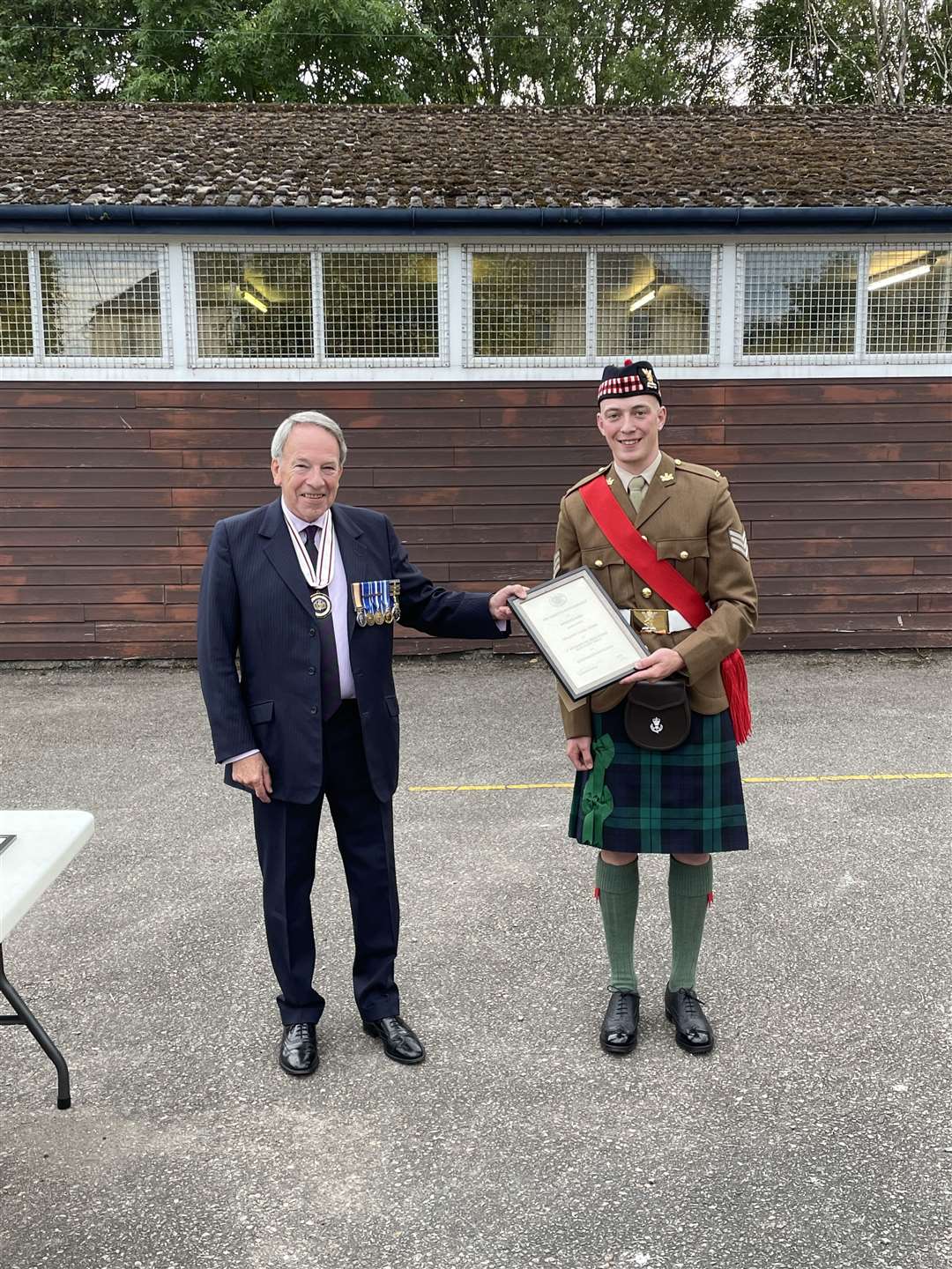 Sgt Samuel Stubbs receiving his certificate of appointment from Vice-Lord Lieutenant Douglas Young.