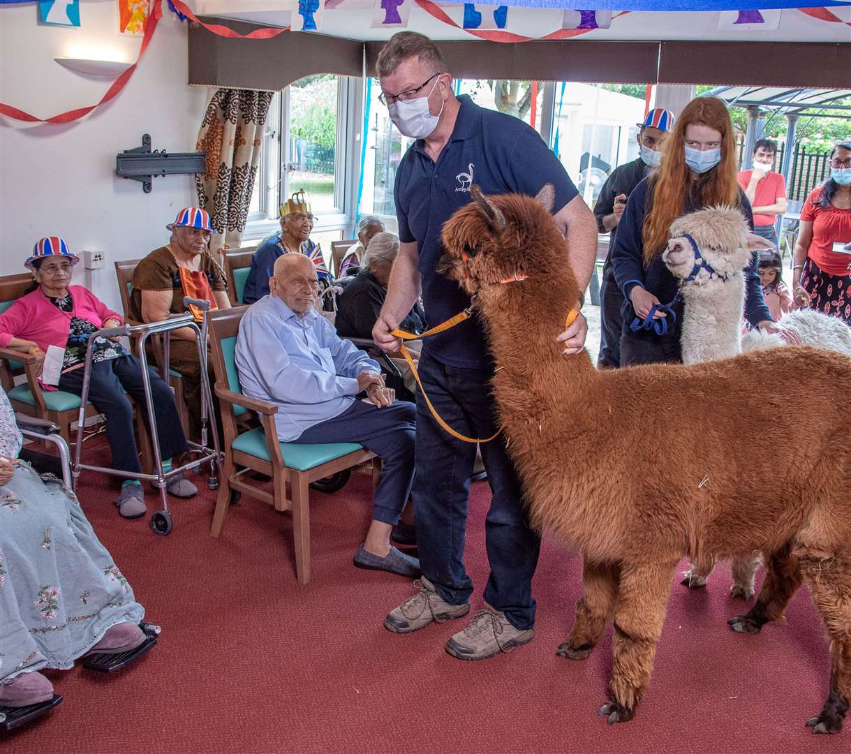 Residents with alpacas at Asra House Residential Care Home in Leicester (Sanctuary Care/PA)
