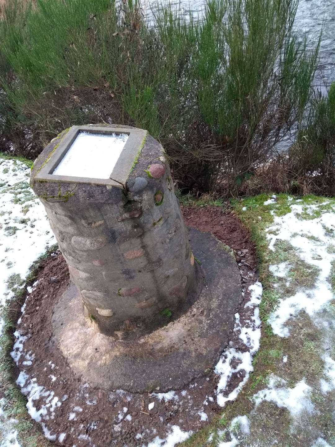 The memorial cairn is under threat of ending up in the river.