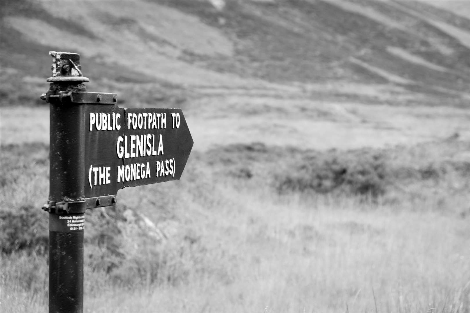 Pointing to the south from the A93 near Braemar, this old cast-metal sign marks the northern end of the Monega Pass. It is a post World War II design, the current design from 1948, but originally put up in 1885. Picture: Richard Barron, RKAB Works