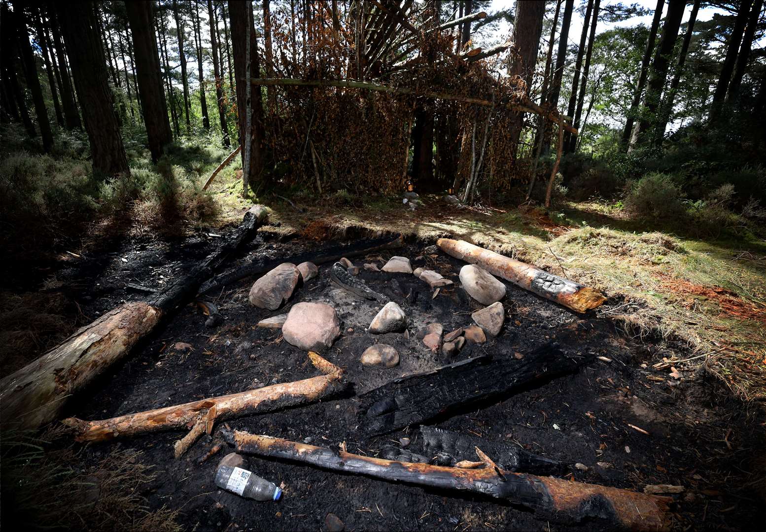 The fire spread and even burnt the logs that had been placed to be used as seating. Picture: James Mackenzie.