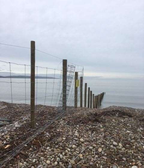 The fence stretches below the high water mark into the sea.