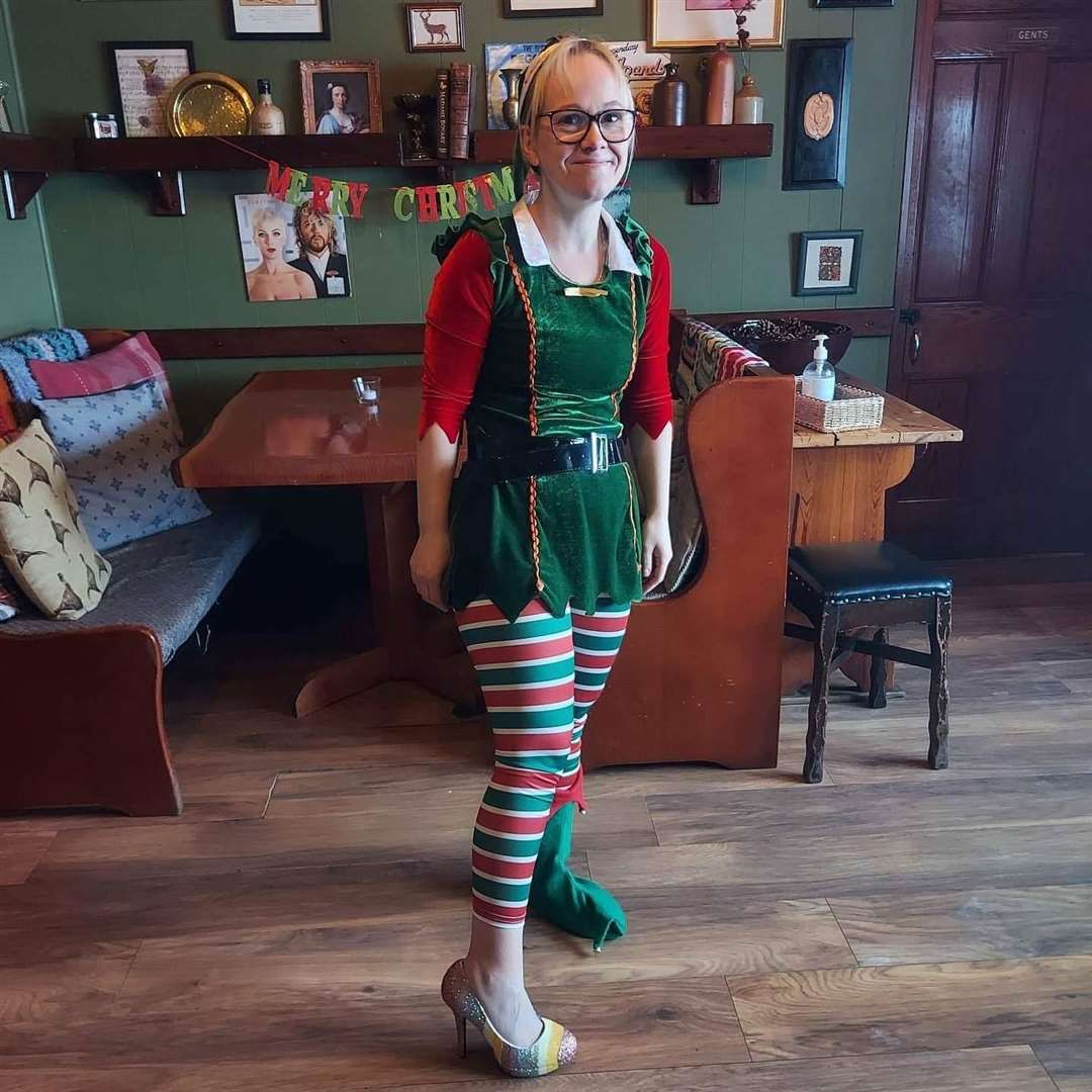The hotel's elf posing with one half of the pair of shoes.