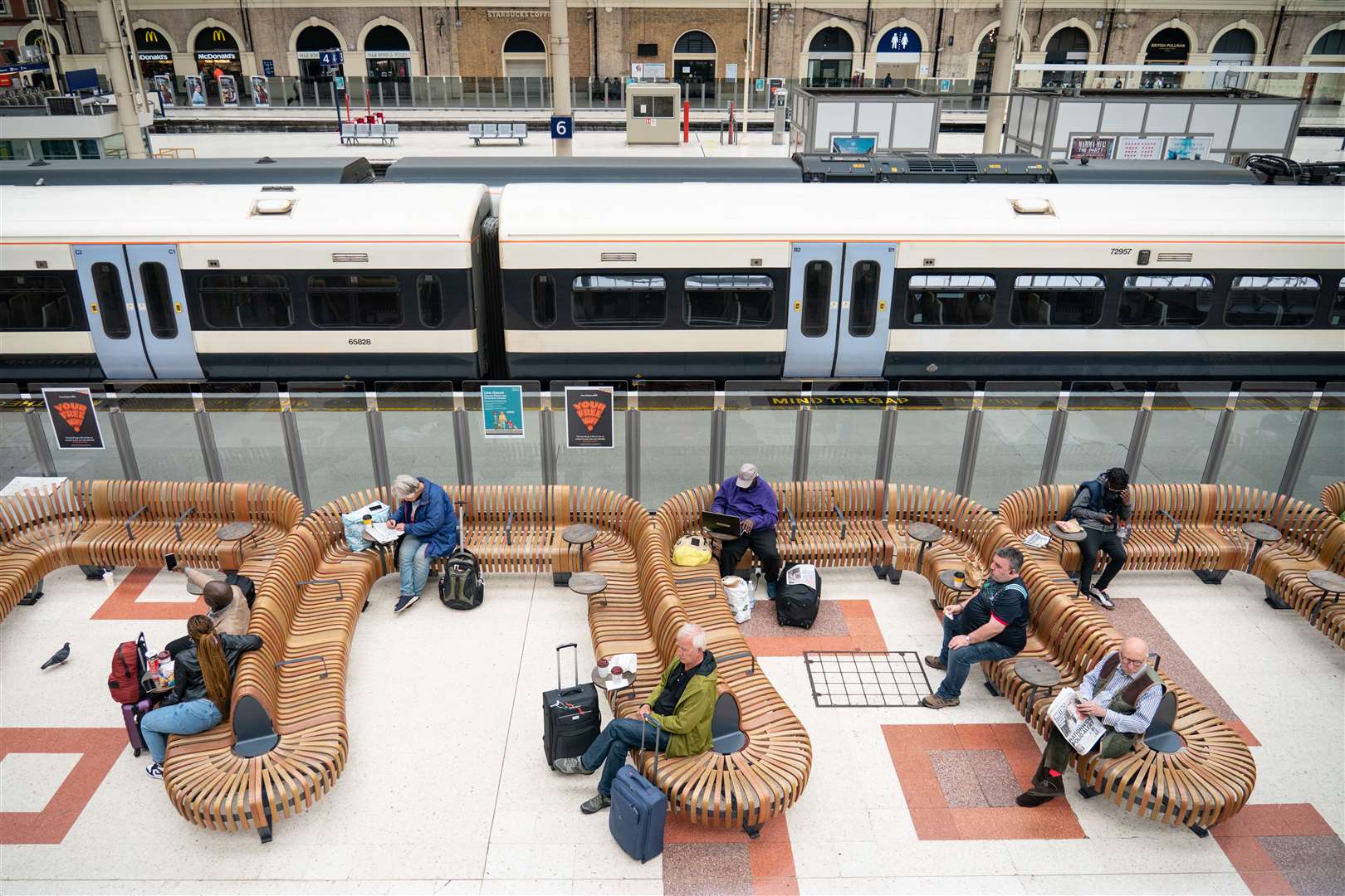 A few passengers wait at Victoria station in London (Dominic Lipinski/PA)