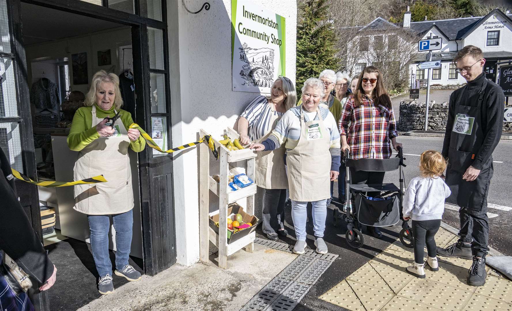 Lynne West cuts the ribbon to officially open the new Invermoriston Community Shop.