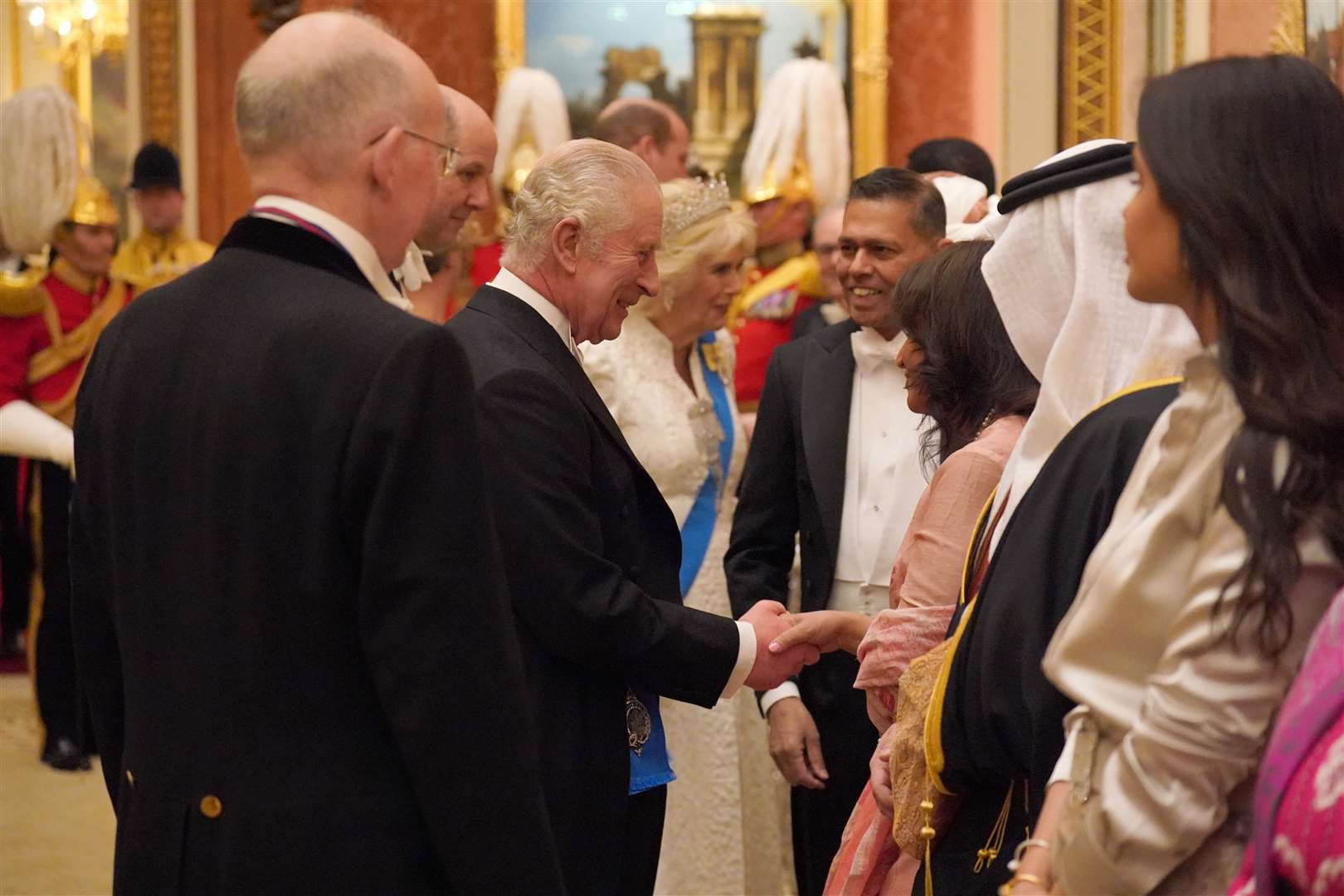 The King and Queen greeted guests at the evening reception (Jonathan Brady/PA)