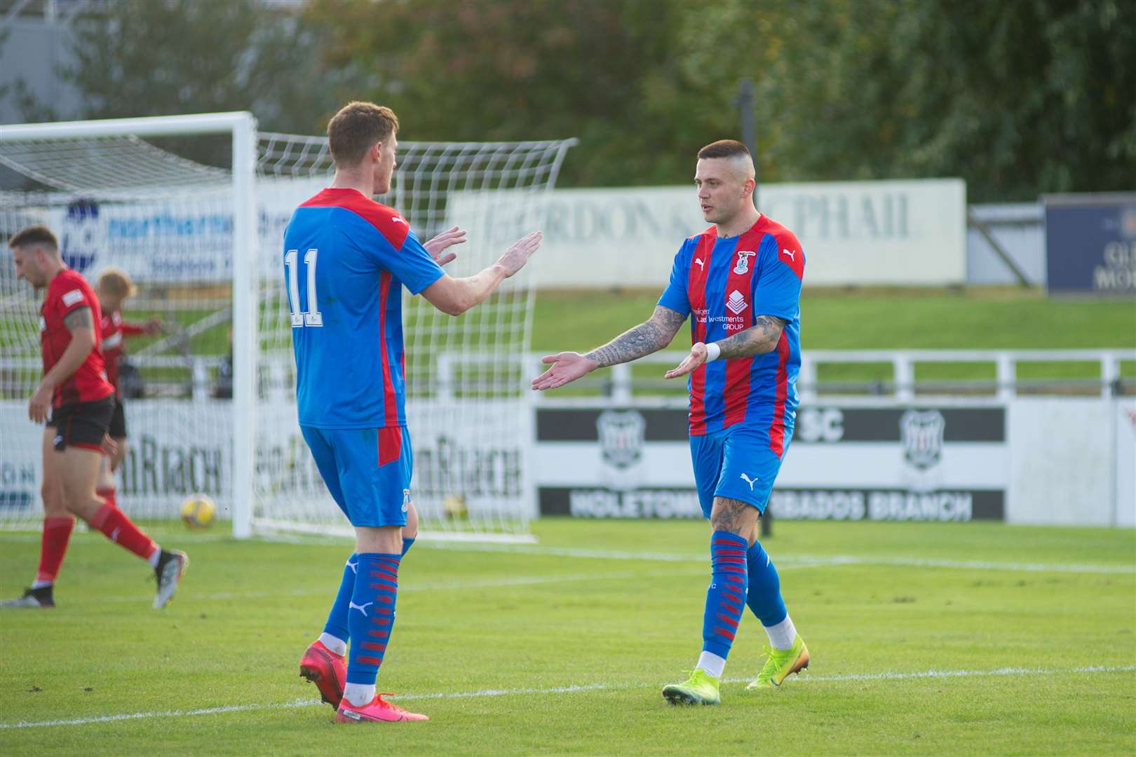Miles Storey (right) and Shane Sutherland celebrate after the sixth Caley Thistle goal.Picture: Daniel Forsyth..