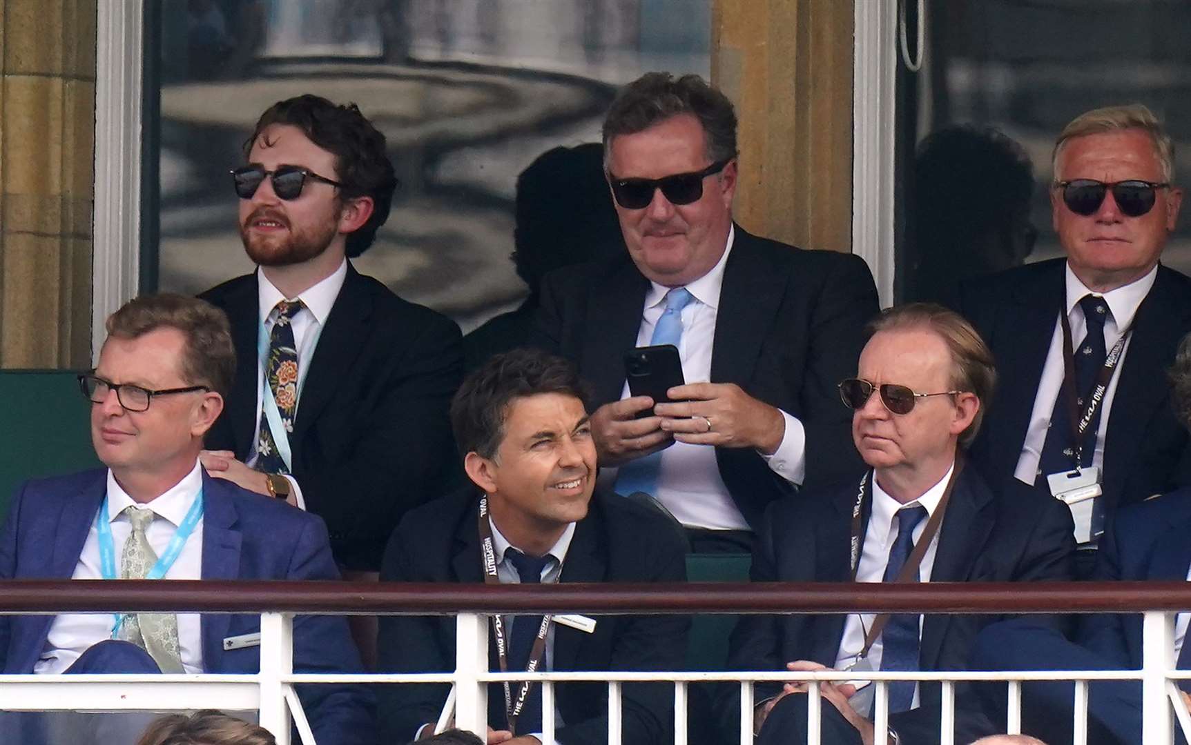 Kevin Lygo (front row, right), sits near presenter Piers Morgan (back row, centre) at a cricket match (Adam Davy/PA)