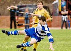 Rory Kennedy (Newtonmore) is tackled by Chris Crawford (Inveraray)