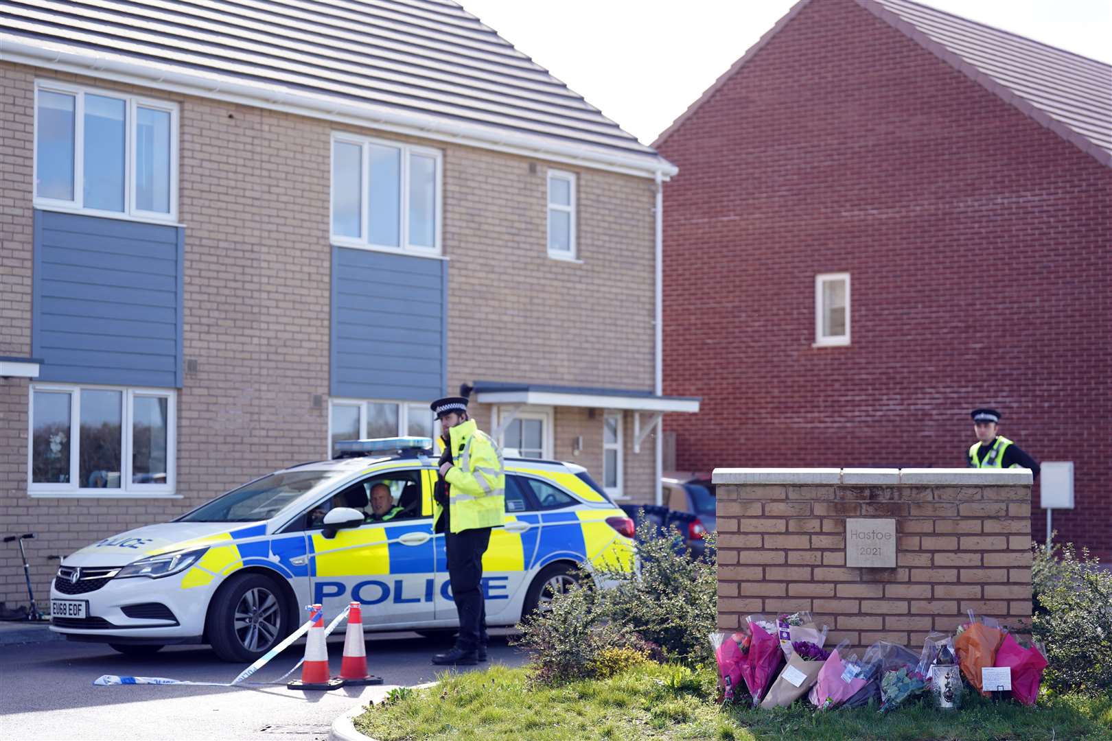 Flowers left at the scene in Meridian Close, Bluntisham, where police found the body of a 32-year-old man with a gunshot wound (PA)