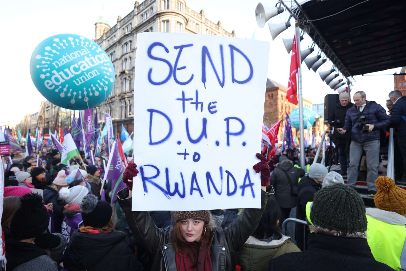 A striking worker holds a sign outside Belfast City Hall, Belfast (Liam McBurney/PA)