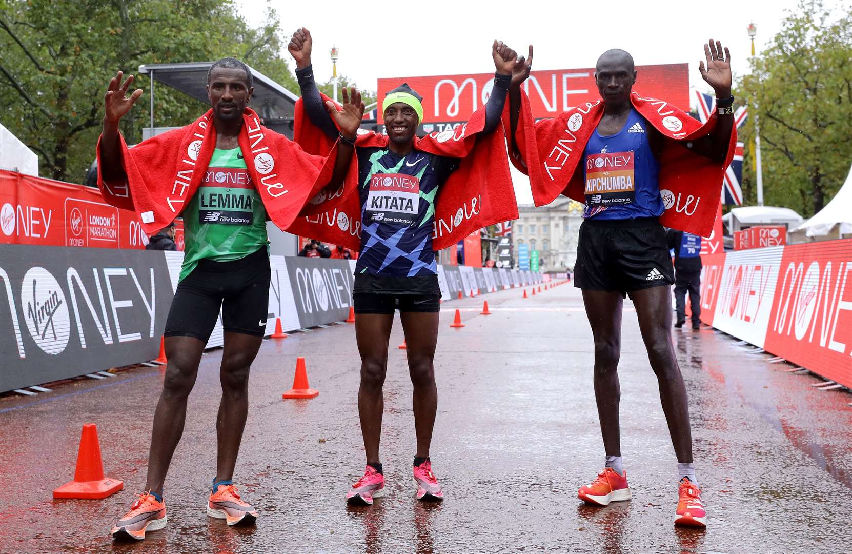 Ethiopia’s Shura Kitata (centre) celebrates victory alongside second-placed Vincent Kipchumba of Kenya (right) and third-placed Sisay Lemma of Ethiopia (Richard Heathcoate/PA)