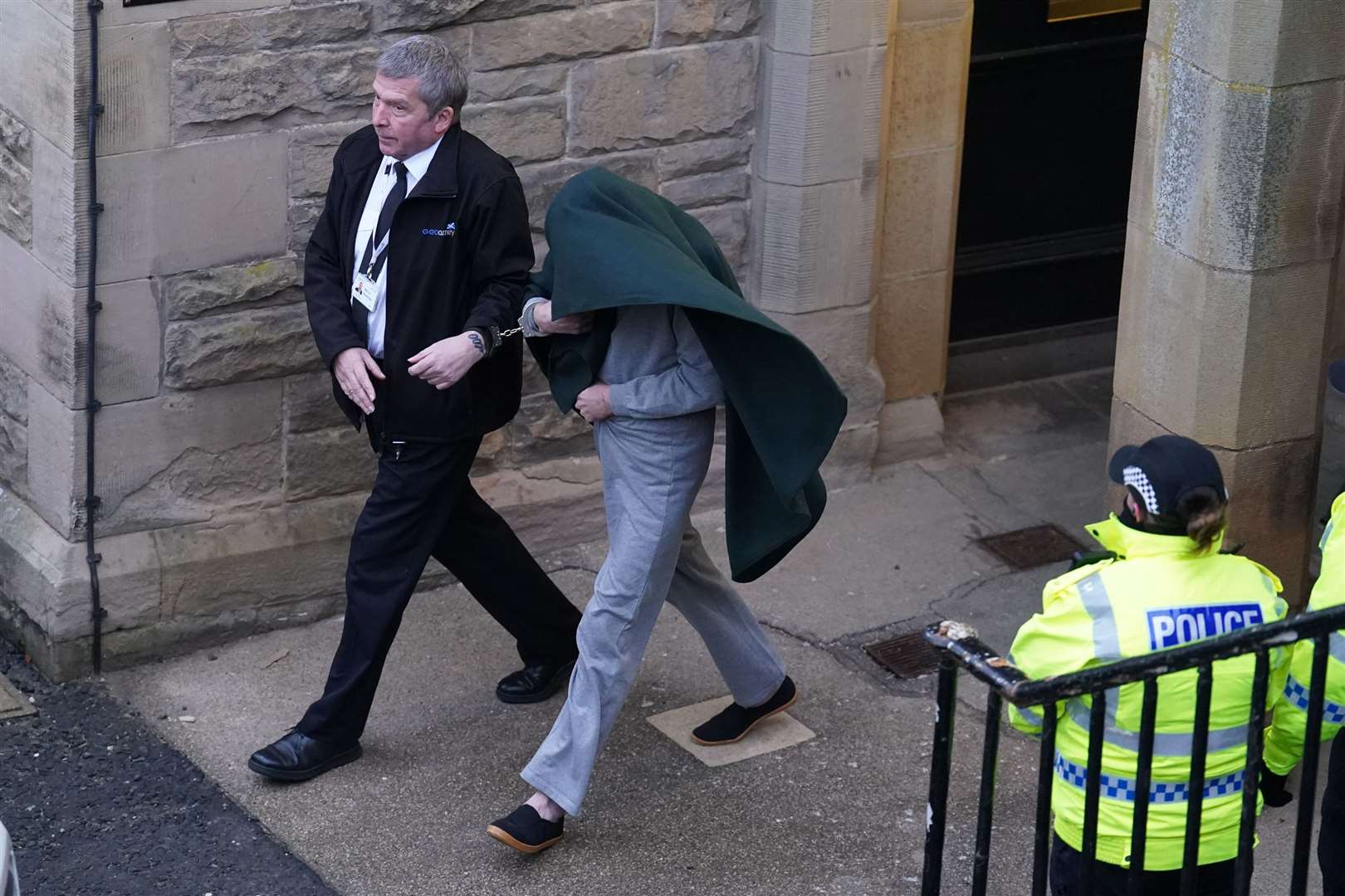 Andrew Miller, under blanket, pictured during a court appearance before his sentencing (PA)