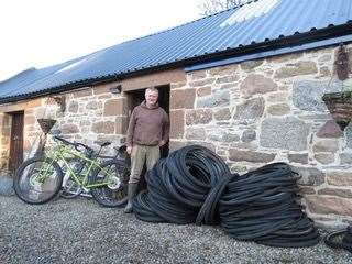 Dr Keith Slater with tyres for recycling.