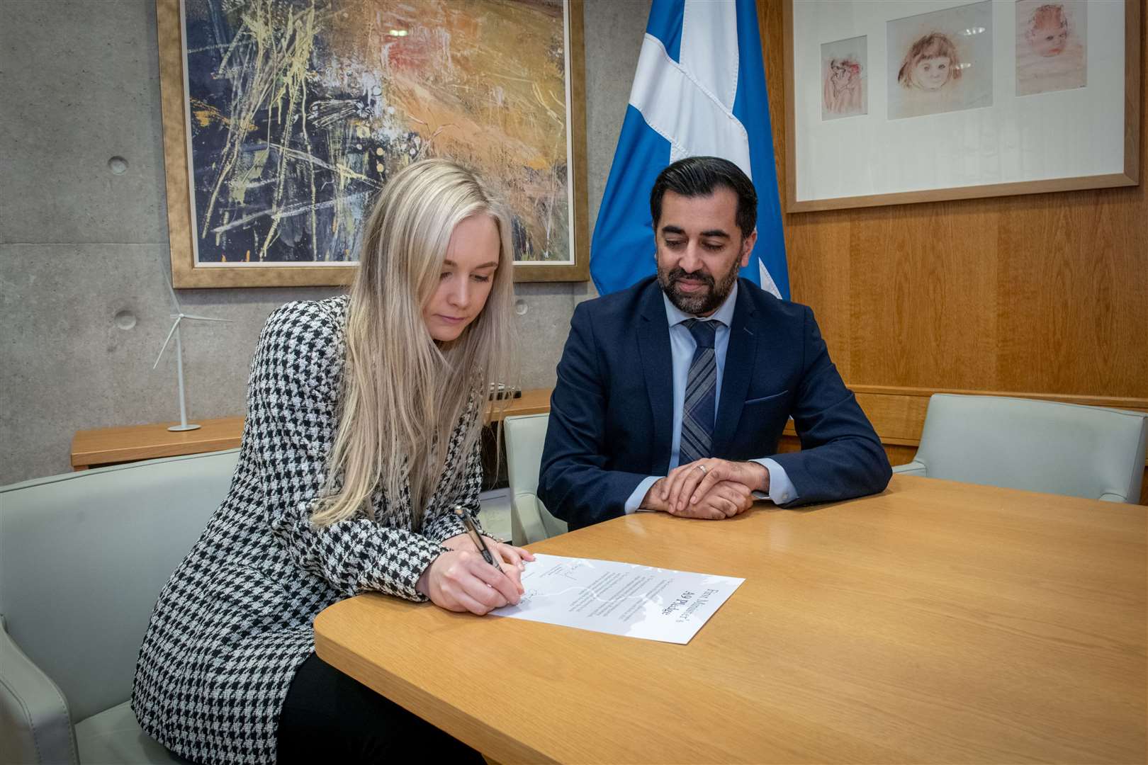 Sarah Fyfe signing the A9 Pledge alongside First Minister Humza Yousaf. Picture: Callum Mackay