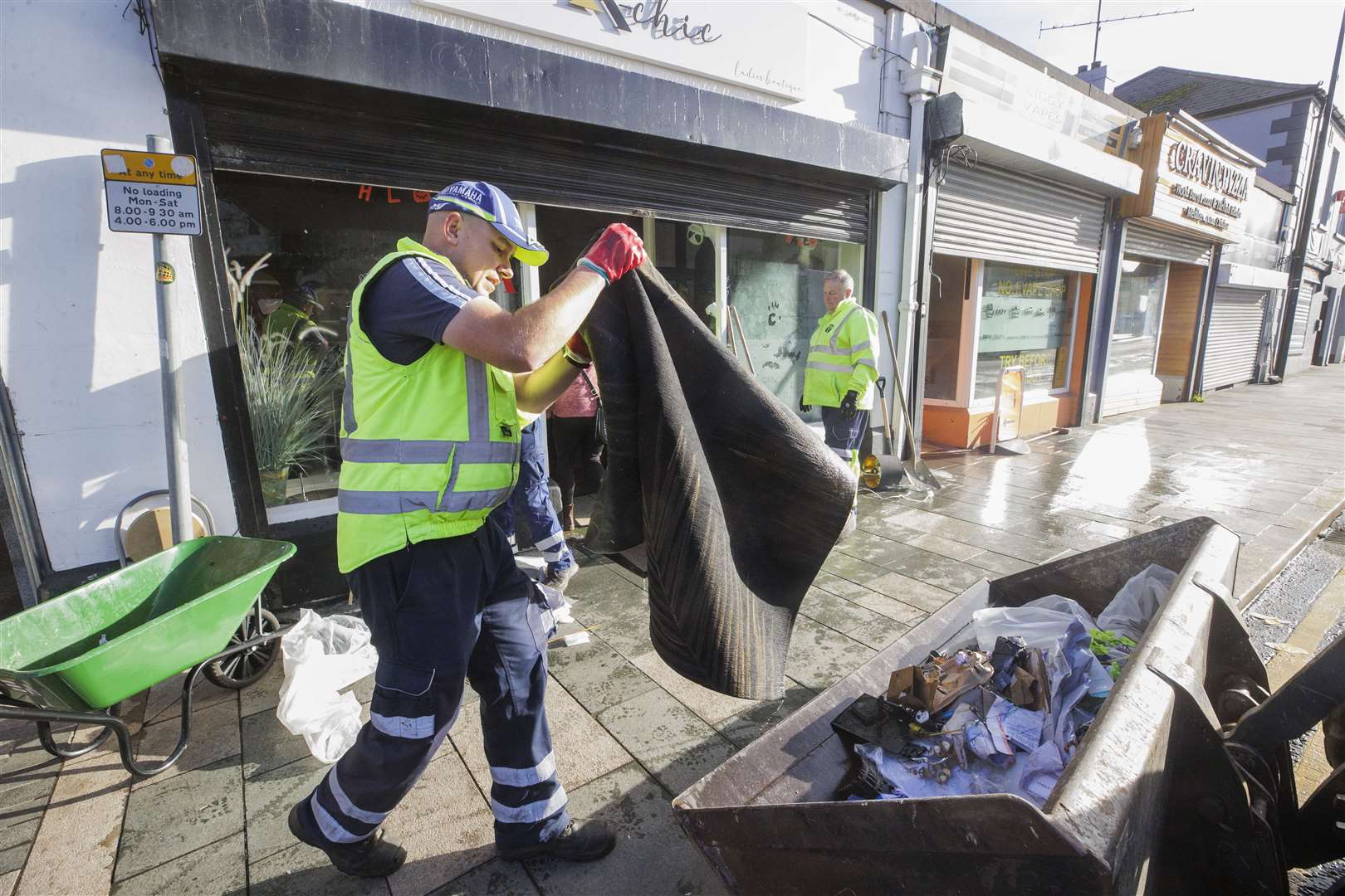 Council workers from Newry, Mourne and Down District Council help clean up flood-stricken Downpatrick, Co Down, where several town centre shops were completely submerged in water (Liam McBurney/PA)