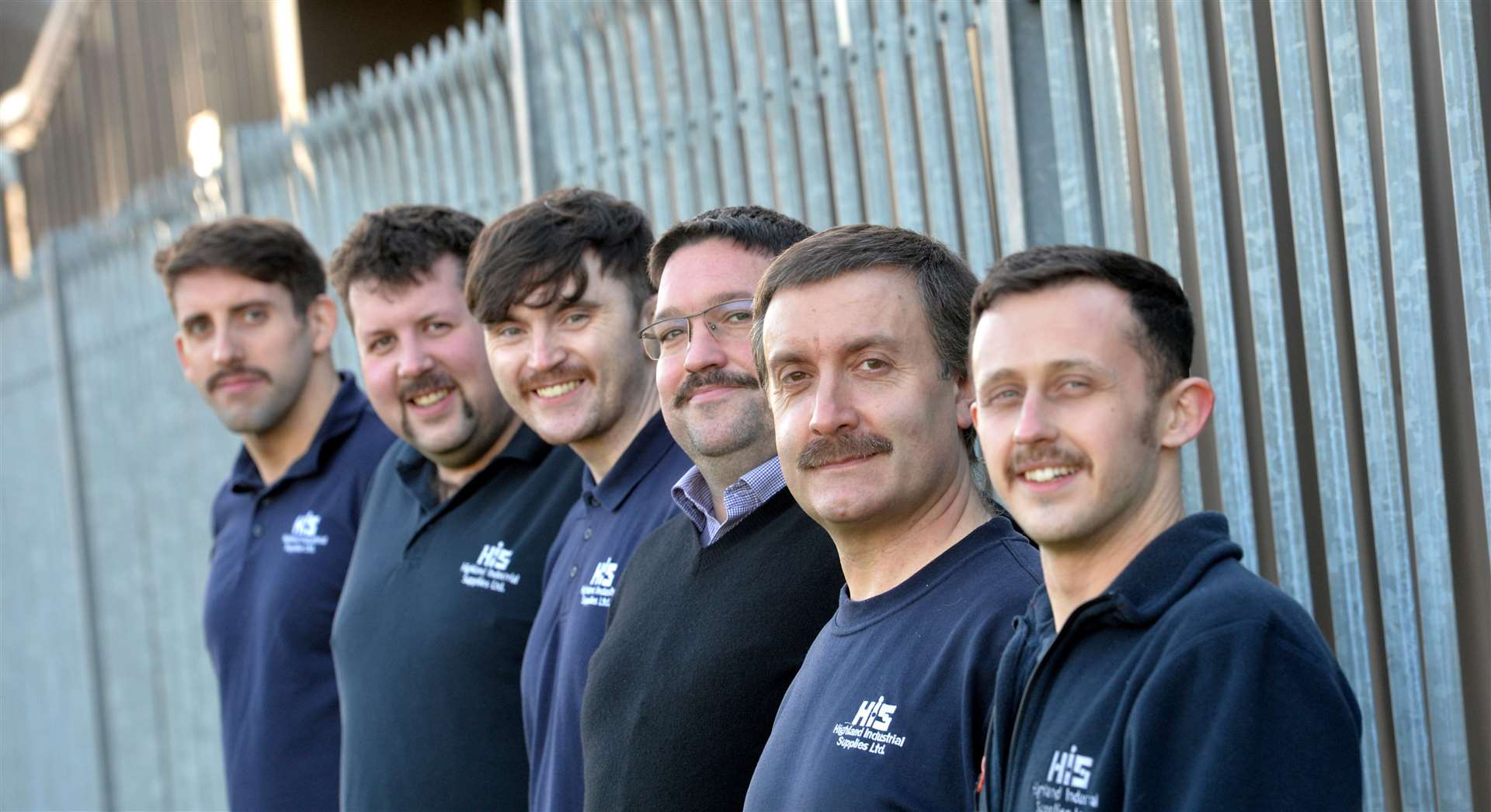 The men at Highland Industrial Supplies show off their moustaches which raised money for Mikeysline.