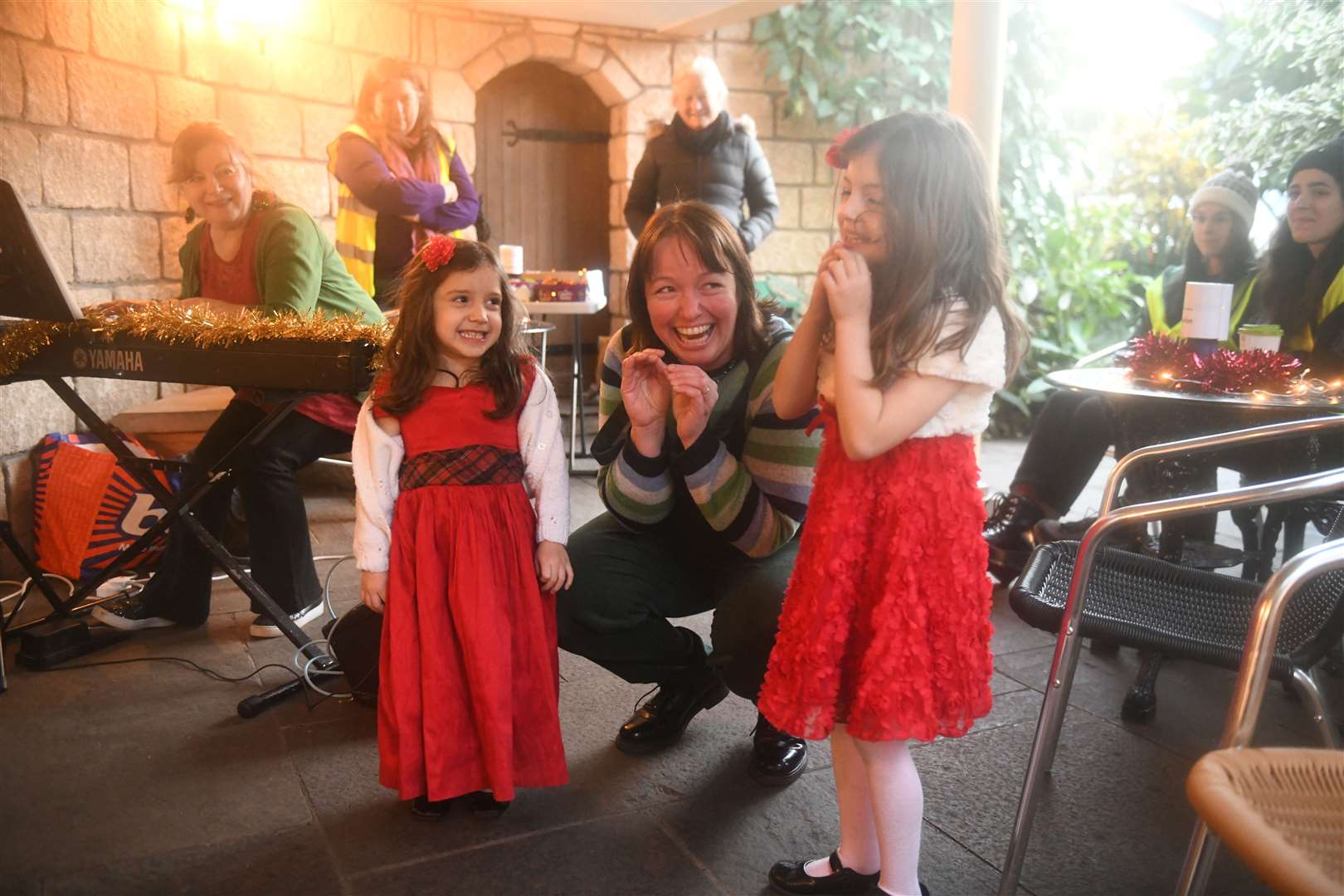 Kaylee Mackenzie, Barbara Henderson and Katie Mackenzie all pretending to be giggling elves. Picture: James Mackenzie.